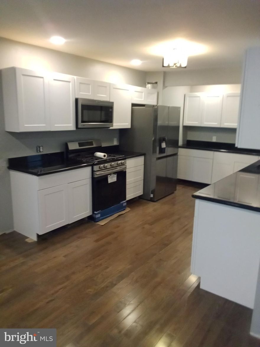 This totally renovated home offers you a modern kitchen with granite countertops and backsplashes, Brand new Stainless Steel appliances and  tons of cabinet space. The finished basement features a wet bar for all your entertaining needs that has a granite countertop bar, a full bath and additional living space. This lovely home has hardwood floors throughout , new windows, a new rubber roof and all new mechanicals. The brand new Central Air system will offer great comfort during the summer days.