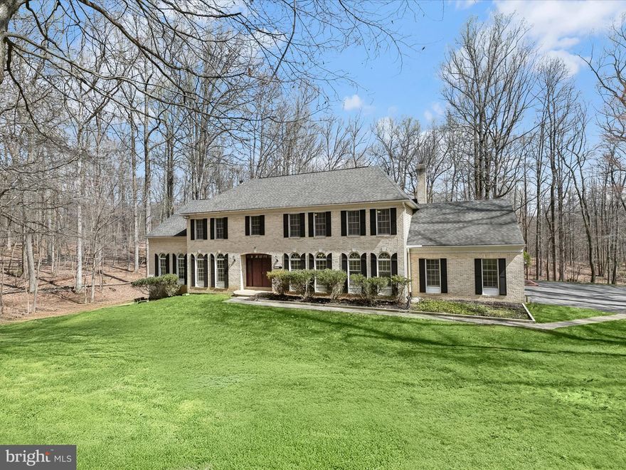 Nestled on over two acres of beautifully landscaped grounds, this stately brick estate in the prestigious Waterspout community offers an unparalleled blend of elegance, comfort, and multigenerational living. A private cul-de-sac location and a long, scenic driveway set the stage for this remarkable home, complete with an additional building featuring a sauna and an enclosed porch—an idyllic retreat within your backyard.  Step into the grand foyer, where soaring ceilings, a curved staircase, and gleaming hardwood floors create an unforgettable first impression. The formal living and dining rooms exude timeless sophistication, adorned with crown molding, chair rail detailing, and a stunning Palladian window that bathes the space in natural light.  Designed for culinary excellence, the gourmet kitchen boasts ceramic tile flooring, granite countertops, 42” custom cabinetry with soft-close and pull-out drawers, a breakfast bar, double sinks, an island, stainless steel appliances, and a walk-in pantry. Adjacent, the breakfast room captivates with a vaulted ceiling, ceiling fan, and a cozy gas-burning fireplace, leading seamlessly to a spacious rear deck overlooking mature trees—perfect for outdoor entertaining.  A double-sided wood-burning fireplace serves as the heart of the inviting family room, complete with crown molding, a ceiling fan, and a charming window seat. The adjacent den, highlighted by recessed lighting and a sunroom entry, offers a tranquil retreat, while the plushly carpeted office with a Palladian window provides an inspiring workspace.  The upper level is a sanctuary of comfort, led by the luxurious primary suite featuring a cathedral ceiling, French door entry, two walk-in closets, and an opulent ensuite with a jetted soaking tub and glass-enclosed walk-in shower. Four additional generously sized bedrooms and two full baths complete the sleeping quarters.  Designed for versatility, the fully finished lower level presents a sprawling recreation room with luxury vinyl plank flooring, a full bath, an additional bedroom, and space ideal for a home gym or private retreat, all with easy access to the utility and storage rooms.  Completing this extraordinary residence is an attached three-car garage and premier access to major commuter routes, including I-695 and I-83, ensuring seamless connectivity to destinations north and south.  This distinguished estate offers the perfect balance of grandeur, functionality, and tranquility—schedule your private tour today!