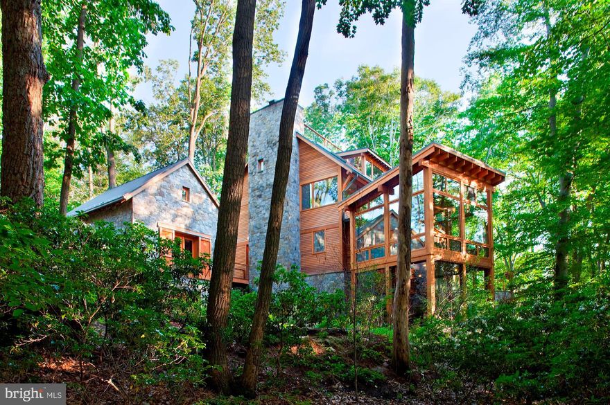 Nature lovers paradise! Exterior of cedar and stone nestled in the trees with Potomac River views! Every Room of the home allows you to experience the outdoors. Stream feeding into the Koi pond, porches and patio with spectacular views! Jim Rill Architect masterpiece with wide plank oak and flagstone flooring, exercise pool, elevator, generator, geothermal heating and cooling, artist's studio, three fireplaces. The home is in the Merry Go Round Farm Community that has two barns, an equestrian center for horse boarding and riding lessons, miles of hiking and riding trails, on site groundskeepers and barn hands, and lighted tennis courts.