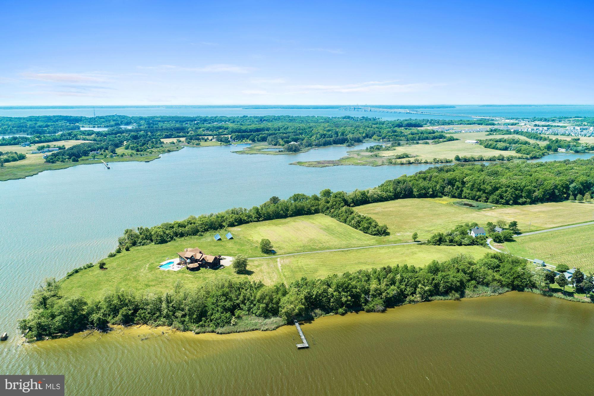 Beautiful Kent Island, Waterfront farm on 28.97 acres. This property is position on a point with 3,000 plus ft. of waterfront. Dramatic entrance with custom staircase, soaring wall of windows with breathtaking expansive water views, that creates a stunning entrance & impressive living room. Custom built home by Lindal Cedar homes, 7852 sq. ft. home, 4 bedrooms, 5.5 baths, 4 fireplaces & 4 car attached garages. There's a barn with stalls, a potential care takes residences needing rejuvenation. Deepwater with 6ft at pier where two rivers come together at the point Thompson creek & Cox Creek, creating this one of a kind property. This property is currently farm for crops plus has two hunting blinds. Amazing location, this home has public water sewer.