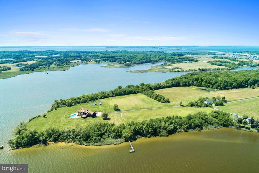 Beautiful Kent Island, Waterfront farm on 28.97 acres. This property is position on a point with 3,000 plus ft. of waterfront. Dramatic entrance with custom staircase, soaring wall of windows with breathtaking expansive water views, that creates a stunning entrance & impressive living room. Custom built home by Lindal Cedar homes, 7852 sq. ft. home, 4 bedrooms, 5.5 baths, 4 fireplaces & 4 car attached garages. There's a barn with stalls, a potential care takes residences needing rejuvenation. Deepwater with 6ft at pier where two rivers come together at the point Thompson creek & Cox Creek, creating this one of a kind property. This property is currently  farm for crops plus has two hunting blinds. Amazing location, this home has public water sewer.