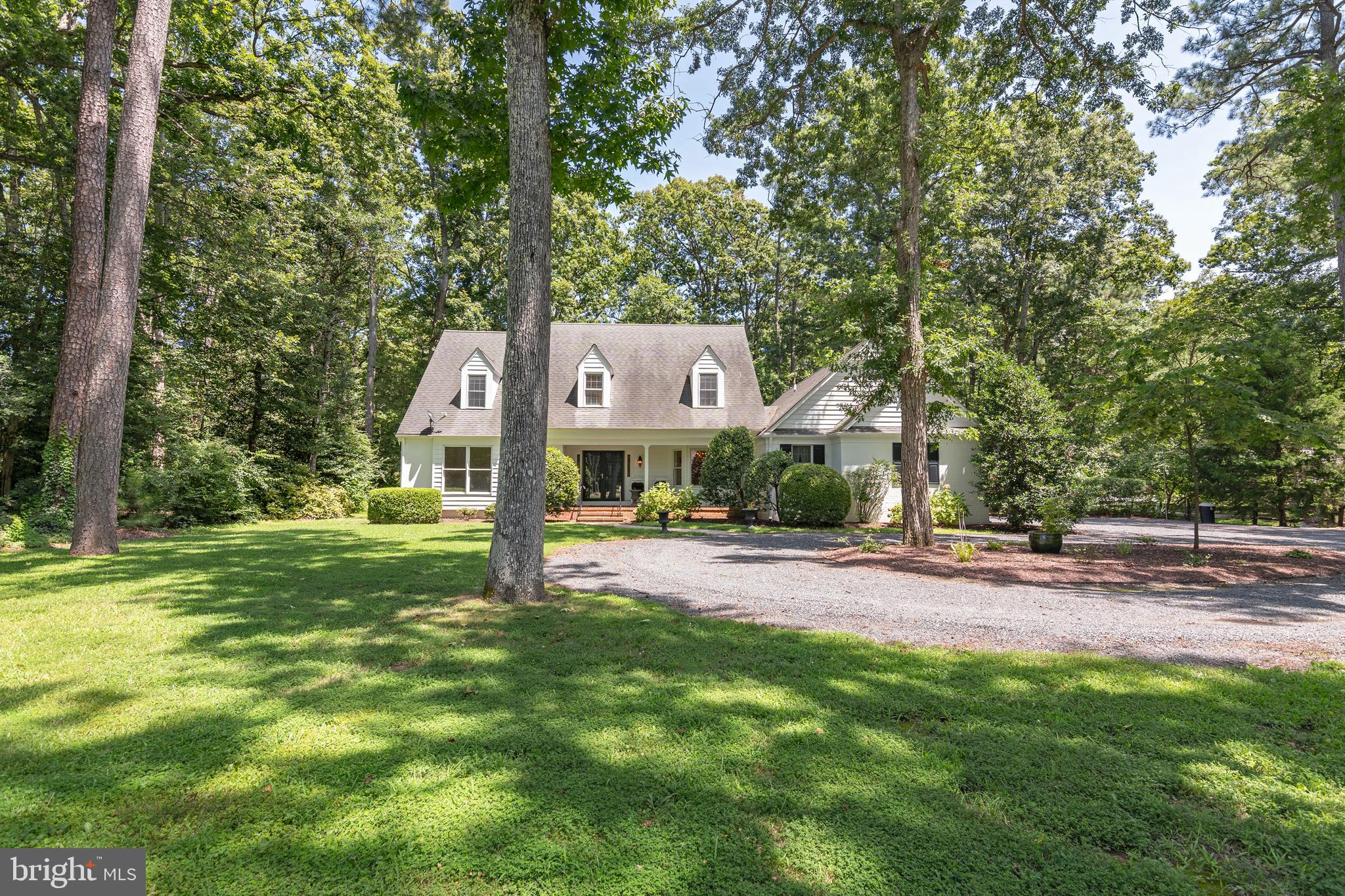 This stately and well-constructed brick/wood cape cod majestically sits on a prime corner lot in the extremely desirable community of Martingham. The ideal floor-plan features a main floor primary bedroom and 3 second floor guest bedrooms. Beautiful hardwood flooring, custom built-ins, fireplace, 2 story foyer, screened porch , deck, covered front porch, circular driveway with extra parking pad, an over-sized 2 car attached garage, granite countertops , formal dining room and an inviting great room off the kitchen are all outstanding features that highlight this home's perfect design and craftsman.
