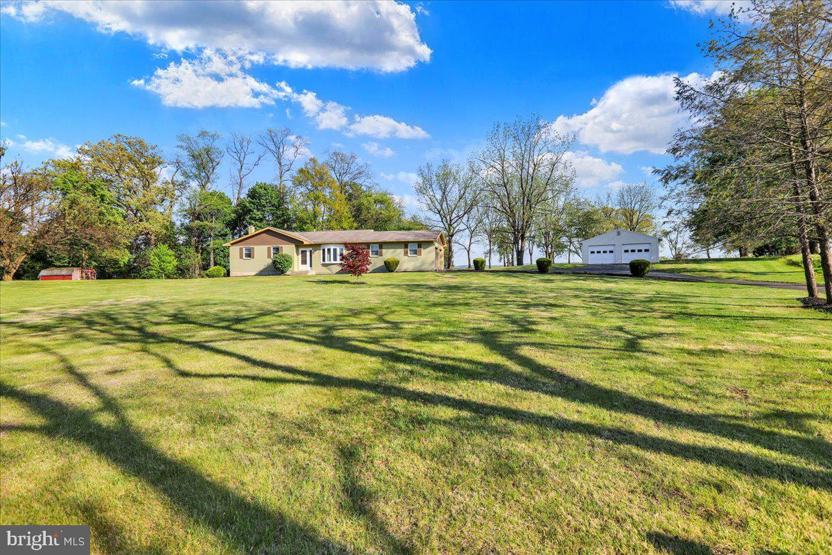 This home was completely rehabbed in 2019. Rehab includes electrical, plumbing, on demand hot water, heating and air conditioning. All new flooring and upgraded kitchen. Sunken living room, with three nice size bedrooms. The full bath is large in size and has a large tiled walk-in Roman shower. Covered rear patio. House is equipped with a generator hook up and also an RV plug-in. Plenty of storage with the two car attached and a 21 x 21 two car detached garage all situated on just shy of 4 acres. This is a move-in property in a great location and a quiet country setting. This is a must see property to appreciate everything it has to offer.