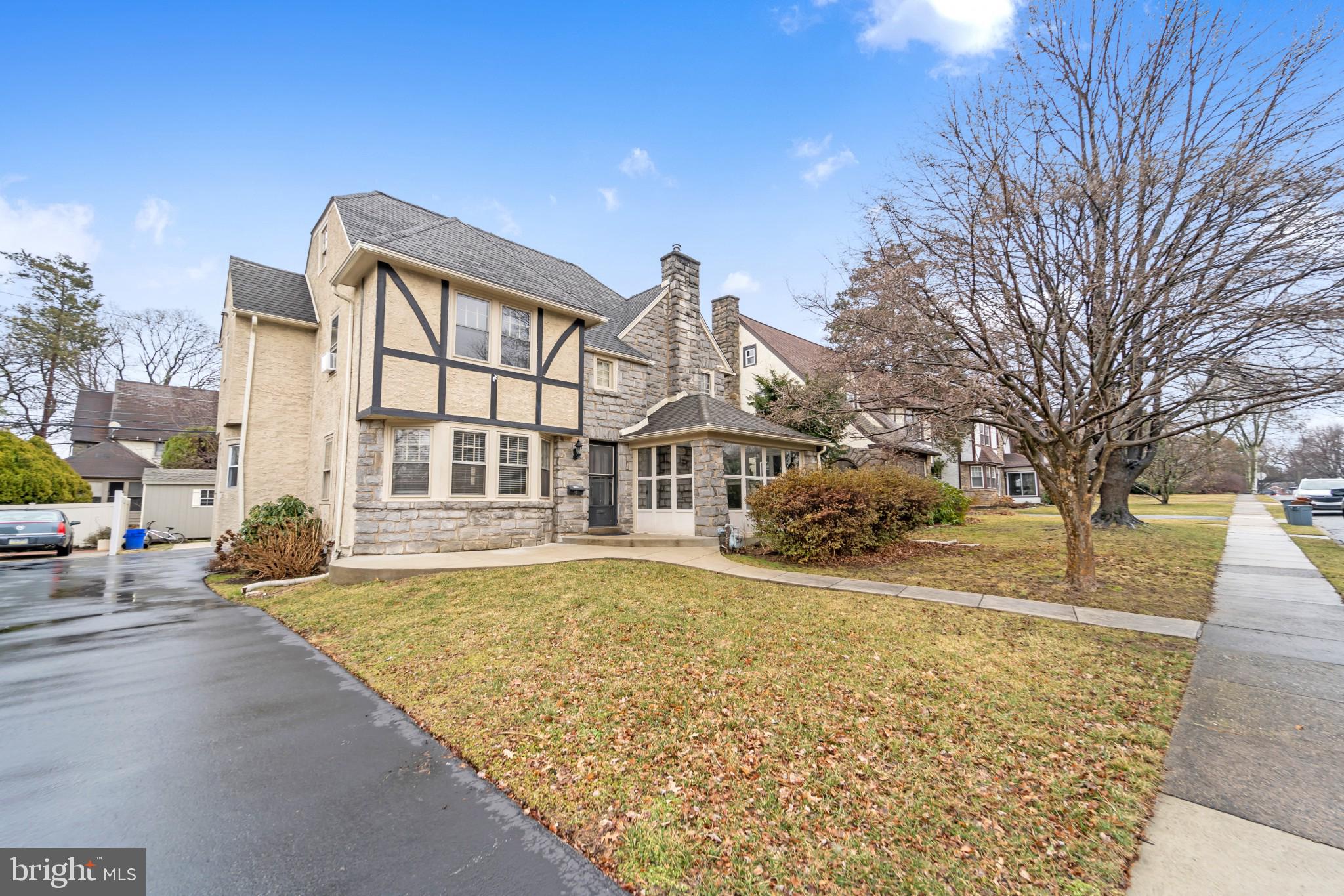 Settled perfectly on a non thoroughfare, tree lined street in the Aronimink section of Drexel Hill, 1117 Belfield Ave is an exquisite Tudor stunner. This home offers old world construction and charm with wonderful modern upgrades. Entering through the foyer the first thing you'll notice is superbly detailed and well maintained hardwood floors throughout. Large windows in the dining and family rooms let in ample natural light. The family room holds a stone, wood burning fireplace perfect for cold winter nights. Take notice of the original stone wall in the fully screened in front sun room, just the right place for afternoon tea or catch up on a favorite book. Continue through the family room to find an in-law suite complete with a full bathroom, washer and dryer combo. Make your way to the kitchen boasting a breakfast nook, granite counter tops, gas cooking range, classic white cabinetry and stainless steel appliances. Upstairs you'll find four nicely sized bedrooms. The master bedroom comes with a master bath and a large walk in closet. The remaining bedrooms are a nice size sharing a hall bath. There is a partially finished walk up attic, ready for a game room or with finishing touches, a man cave. The basement is unfinished with two new windows and hookups for washer and dryer. There is a fenced in back yard with room to park two cars in the shared driveway. Restaurants, cafes and shoppes all within walking distance, 20 minute drive to Philadelphia. 200 amp electric service, newer roof, new heater to be installed.