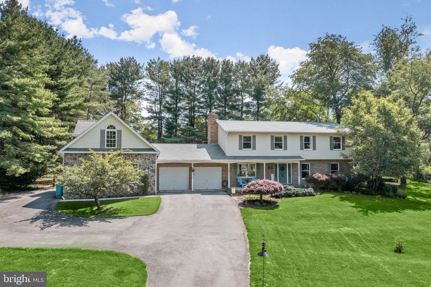 This beautiful, private, and semi-secluded colonial on pristine landscaping with space for a  garden, and secure storage for lawn tools, and is settled amongst mature trees with an abundance of outdoor living possibilities.  Arrive through the front porch and pass the strawberry patch or the convenient two-car garage and enter an open main level that offers gorgeous hardwood floors that continue throughout and accents the chair railing and neutral color palette.  Let the eat-in kitchen inspire delectable delights boasting a sizable pantry, planning station, pull-out classic style cabinetry, a center island, stainless steel appliances, a breakfast area, and granite counters.  Spend time with family and friends in the spacious family room that is adjacent to the kitchen and offers a wood-burning stove fireplace and access to the rear yard and in-ground pool for a seamless transition from indoor to outdoor entertaining.  Relax and unwind through the French doors and into the sprawling primary bedroom suite adorned with plush carpet, a wood-burning fireplace for cozy evenings, two closets, one being a walk-in closet, double vanity, and a ceramic tile walk-in shower. Three additional bedrooms and a hall bath complete the upper-level sleeping quarters.  The lower level awaits and provides many opportunities as a game, recreation, media, or office space with a pellet stove, brick accents, and paneled wainscoting that brings warmth and sophistication.  More to come in this spectacular home with an attached carriage house offering a plethora of options as a fitness area, a workshop for your motor vehicles,  weekend projects, or convert into a guest house. Enjoy morning coffee, tea, or evening cocktails, and be inspired by the tranquil atmosphere with stunning views of butterflies and the soothing sounds of nature on the rear deck.  Major commuter routes include MD-32, I-695, and I-70 for travel to points north and south.  Updates: Heat Pump, Pool Filter
