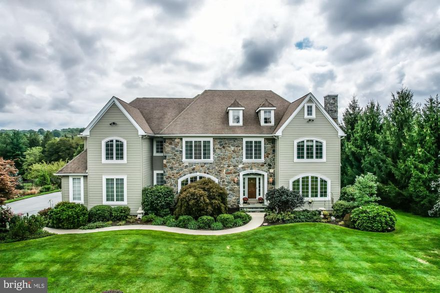 Stately and elegant stone and Hardie Plank siding estate home on a cul-de-sac of luxury homes in the Chadds Ford School district.  Located in the heart of Brandywine Valley, this beautiful and meticulously maintained property with a lovely and convenient side portico entrance, 3 bay car garage and walkway with landscape lighting,  front and rear yard irrigation system, ornamental shrubs, plantings and flowers.  This is a spectacular setting for a home that features 5 bedrooms, 5 full bathrooms, 2 powder room and over 6,000 square feet of living space plus and additional 1,300 finished walk-out basement with all the conveniences for ease of living.  Dramatic entry welcomes you to a 2 story foyer with a straight through view to French doors leading to a huge maintenance free Wolfe deck and Gunite 6 foot deep pool with spa.  Gleaming hardwood floors through entire first floor with exception of carpet in office and tiled sunroom.  Custom crown molding throughout this spectacular home.  Living room highlighted by direct vent gas fireplace adds a cozy touch.  Entertain in comfort in this spacious dining room which leads to Butler pantry, huge storage pantry and gourmet kitchen.   Enjoy meal preparation in this open kitchen with huge 2 tiered granite island, cherry cabinetry, new Wolfe range top with exhaust fan, new rectangular stainless steel sink and loads of work space.  Sunny large breakfast area with French doors to  large deck and rear fenced yard with pool.  Family room off of kitchen with coffered ceiling, LED lighting and direct vent fireplace with sconces on each side.  Working from home or home schooling in this 1st floor office featuring see-thru fireplace to sunroom  which can also be used as a second study or music room.  Conveniently located foyer powder room right outside the office.  Mudroom back hall area offers direct access to outside side entrance, coat closet,  access to 3 car garage, refinished powder room a rear staircase to the 2nd floor.  The second floor main bedroom is situated privately from the other bedrooms with a sitting room, large walk-in closet and a renovated bath with double vanities, new epanded tiled seamless shower and separate water closet for privacy.   Four additional bedrooms, 2 featuring their own full bathrooms and 2 with Jack and Jill bathroom.  Conveniently located 2nd floor laundry with cabinets, large countertop for folding, sink and storage closet.  Finished walkout lower level with exercise room, full bathroom with shower, wet bar with built-in cabinets and fridge, dishwasher and microwave, eating area, and  large family recreation room with French doors to cement patio that leads to salt water pool in the private level fenced backyard with beautiful landscaping. 
Too many amenities to list as well as improvements over the years - naming a few most recently is well pump in 2021, new furnace w/Aprilaire humidifier and air purifier in 2021, new side door and garage doors, 22 KW generator, electric water heater, HVAC Trane units, all fireplaces direct vent gas, plumbing for tub in main bath in wall for future use if desired.
Conveniently located to West Chester and Kennett Square, Longwood Gardens, great restaurants and historical points of interest in the Brandywine Valley.