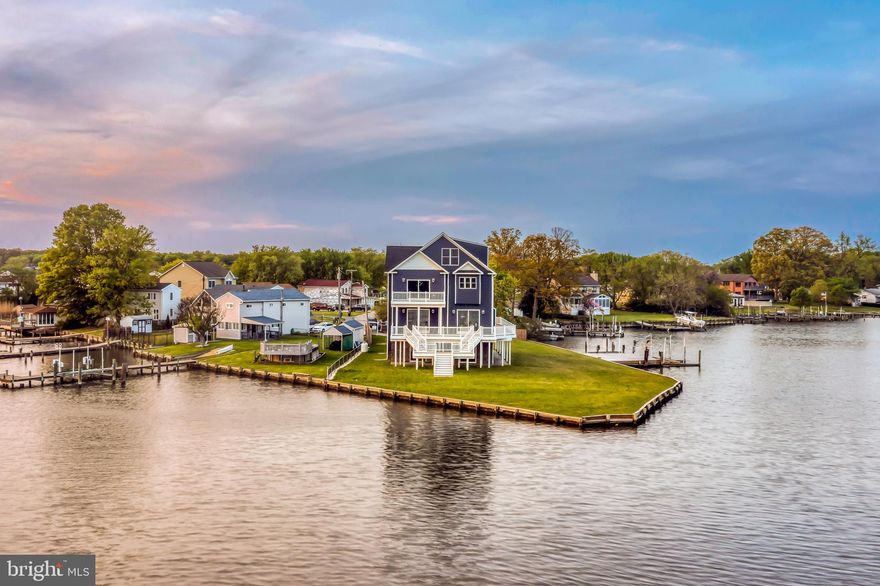 Welcome to 7801 Deboy Avenue. This new construction craftsman beach style smart home sits on a private point on Bear Creek with water views from every single oversized window. This brand new home features over 5,400 square feet of living space with 5 bedrooms, 4 full bathroom, and an extremely rare vantage point of 386 ft of waterfront. Enter through the 4 car garage and travel the grand oak staircase or take the private-4-stop elevator to the next 3 levels. The builder was purposeful in his planning for the property as he widened the entire foot print an additional 5 feet to give a true landing to the elevator step out and to make each bedroom that much bigger. The main level’s open design includes a massive kitchen with 2 elongated islands, black stainless smart appliances, a full bathroom, a bedroom/office and a stone-smart fireplace. All of the appliances were carefully chosen and positioned for efficiency and convenience including the gas stove top that was imported from Italy. Walk out onto over 1,600 square feet of composite decking overlooking the unobstructed and vast views of Bear Creek. The next level showcases 2 additional bedrooms, a full bath, as well as a magnificent owner's suite. The owners suite has a private walk-out balcony overlooking the water and an exquisite owner's bathroom with a standing glass shower, a jetted soaking tub, and two private vanities. This level also includes an extra large laundry room with smart washer and dryer. Again, you can see water from every single room in this home through the custom oversized windows; even in the laundry room. The peak level features a sprawling 27 by 18ft recreation room. Greet guests at the front door using the smart home technology from several locations throughout the home. If this is not enough, walk out to the private pier to enjoy a weekend on the water complete with 2 boat lifts and a jet ski lift. Other features include a tankless water heater, dual zoned HVAC, three quarter inch oak flooring throughout, a smart gated entry, and custom trim and paint package throughout. Don't miss this rare opportunity to immerse in luxurious and serene water front living.