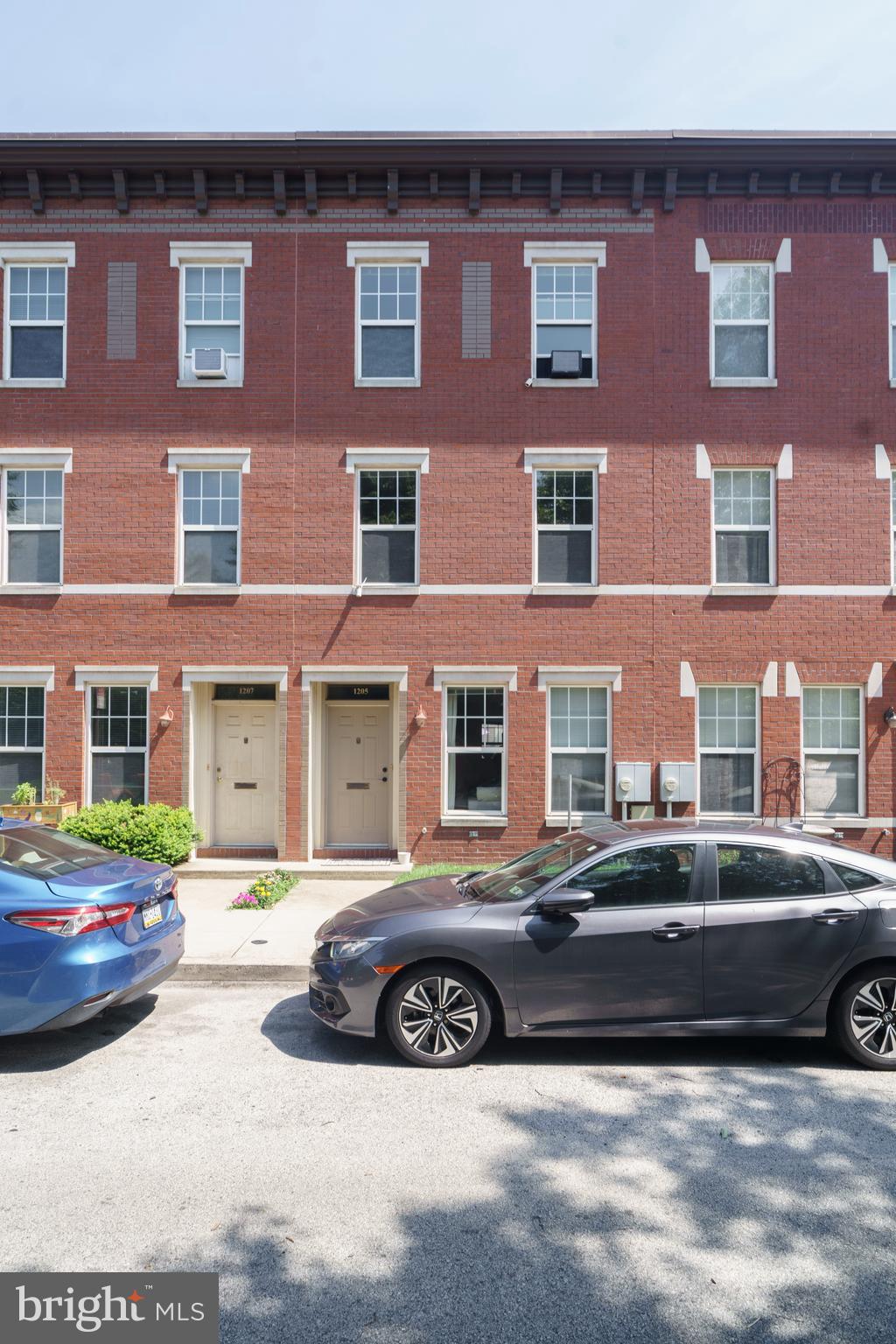 Open House Sunday (7/13) from 9:45am-10:15am. Welcome to 1205 Clymer Street, where location, comfort, and private parking come together in the heart of the Hawthorne/Bella Vista area. Set directly across from the iconic Hawthorne Park and conveniently located near the Broad Street Line, Center City, and PATCO, this rarely offered rental puts you within reach of everything the neighborhood has to offer, including cafés, restaurants, shops, and more, and the best part? Private parking is included. Inside, you'll find a spacious open concept layout with chic flooring and abundant natural light. The main level features a bright living room, a spacious dining area, and a generously sized kitchen with ample cabinetry, plenty of counter space, and a dishwasher, ideal for anyone who loves to cook or entertain. Laundry is conveniently located on the first floor in a private, enclosed area, and central air keeps the home comfortable year-round. Out back, you'll find your designated parking space, which easily fits one car and, with a little finesse, can potentially accommodate two vehicles. Upstairs, the second level offers two generously sized bedrooms, one overlooking Hawthorne Park with fantastic sunlight, and the other facing a quiet rear alley for added privacy. Both bedrooms feature large closets and can comfortably accommodate full bedroom sets. A full three-piece bathroom completes this level. The third floor provides even more flexibility and can be used as a third bedroom, a primary suite, a home office, or a den. This floor also includes a convenient half bath and multiple closets for added storage. Water is included in the rent, and the HOA covers lawn maintenance and snow removal. For added convenience, the home comes partially furnished, including a bed and dresser on the third floor, a dining table and chairs, and couches in both the living room and third floor.