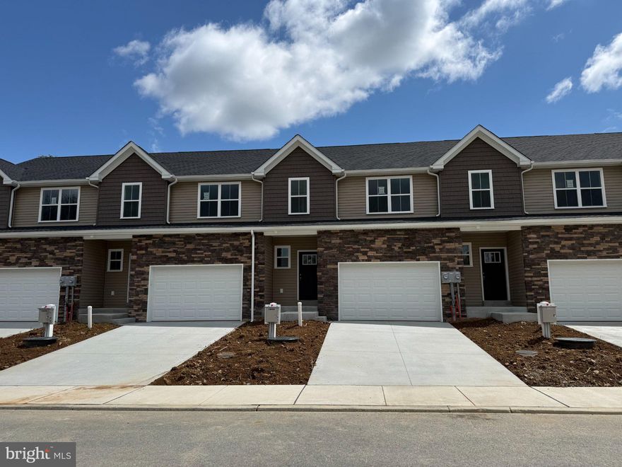 This gorgeous interior unit, modern craftsman-style home turns heads with its eye-catching stone facade, shake accents, and charming front door.  The heart of the home features a stunning, upgraded kitchen with sandalwood cabinets, quartz countertops, and a center island — perfectly connected to the dining and living spaces for easy entertaining or cozy nights in.  The open living spaces is a wide open, soaring great room with vaulted ceilings that instantly feels bright, airy, and welcoming.  Rear sliders lead to composite decks or concrete patios, depending on grade.  Upstairs, the spacious primary suite is your private retreat, complete with a primary bath with double bowl vanity and a walk-in closet big enough to impress. Two additional bedrooms, a full bath, and an oversized linen closet offer space for everyone.  These townhomes are designed with three professionally designed color palettes — so whether your style is bold, warm, or cool and modern, there’s an Addison that fits your vibe. Plus, this is truly low-maintenance living — the HOA takes care of lawn care and snow removal. Pair that with an oversized one-car garage and a location in charming Fleetwood, and you’ve got the ultimate in carefree, luxury townhome living.  One more thing...backed by the one-year Builder Warranty, we've got you covered!