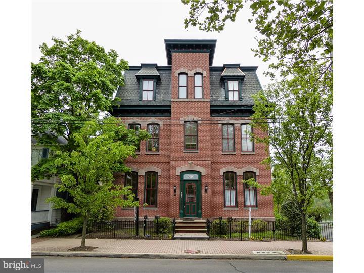In 2010, the Radcliffe, a late 19th century mansion backing up to the Delaware River, the former Bristol Moose Home in historic Bristol Boro, was converted into four luxury condominiums. At 900 Radcliffe Street, every day begins with spectacular sunrises over the Delaware River. This beautiful, two bedroom, two and one half bath condominium, offers two stories of living space with an open floor plan. The main floor features 12' ceiling, hardwood flooring and intricate millwork throughout. Large window offer an abundance of natural light and breathtaking views. Enter into the foyer which opens into a sitting area with a formal library in the front and a formal living room to the left. Continuing down the hall find the formal dining room opening to a gourmet kitchen with 42" custom cherry cabinetry, granite counters and professional grade stainless appliances. Open to the kitchen is a spacious family room with gas fireplace and glass atrium doors to the rear deck. Both rooms offer glorious, panoramic views of the river. Powder room, coat closet, utility and laundry room make the main floor complete. Below are two bedrooms and two full baths including an opulent main bedroom suite with atrium door to a luxurious patio overlooking the river. This spectacular home is offered for $494,900 and awaits your visit.