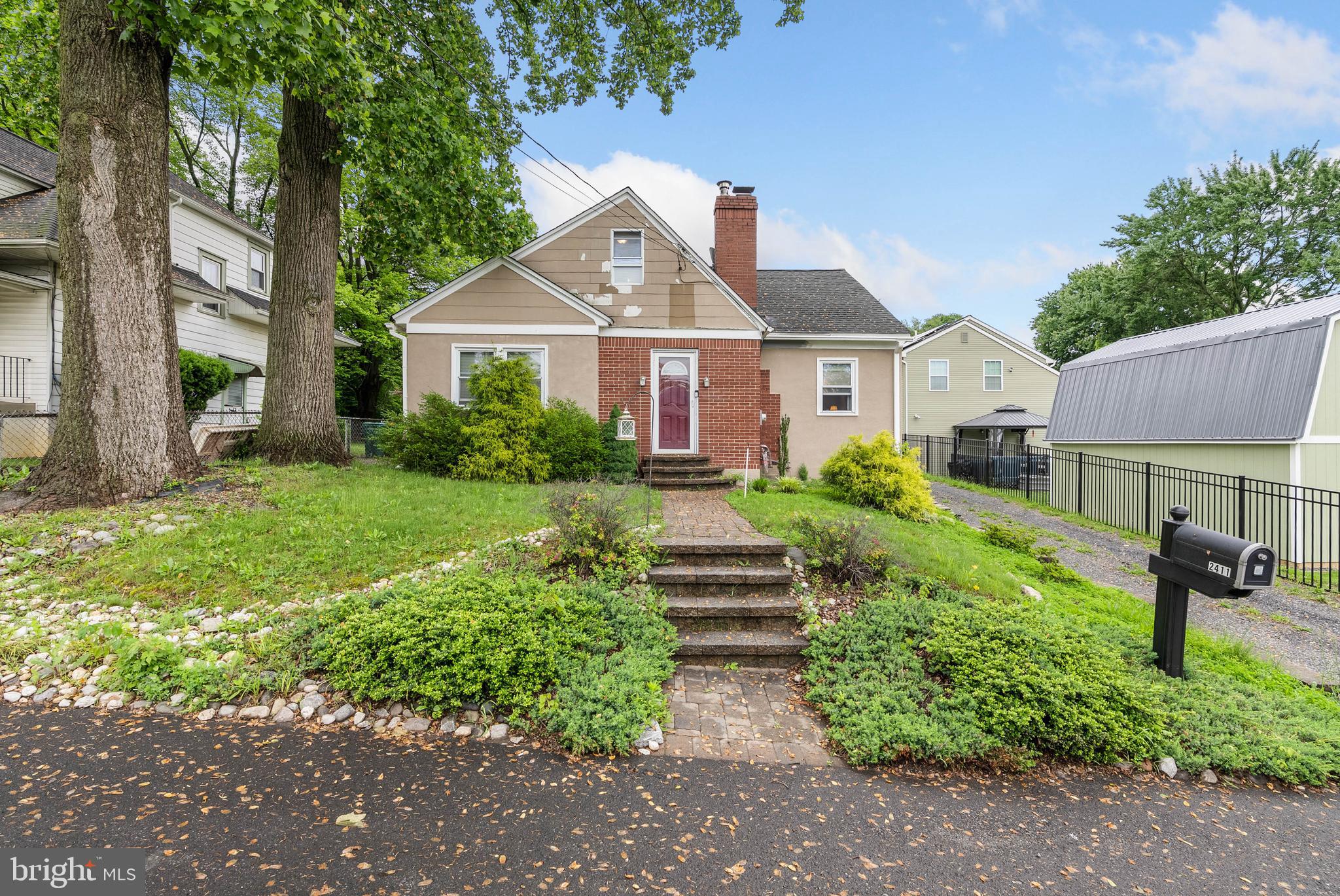 Tucked away on a quiet street just off Old Lincoln Highway in Feasterville-Trevose, you'll find 2411 Paris Ave. This 2-story home has 3 bedrooms, 2 full bathrooms, and a large backyard. Out front, charming curb appeal is displayed in the lush shrubbery, mature trees, cobblestone walkway, and long driveway that leads to a garage with ample parking. A foyer with a coat closet welcomes you inside. Tile floors extend to the spacious, bright living room anchored by a fireplace. The sunlit dining room and updated kitchen are sure to be the heart of the home, boasting generous cabinet and counter space, a full suite of appliances, including a dishwasher, and lots of seating. Completing the main level are two carpeted bedrooms and a full bathroom. Upstairs, there's another large bedroom, a second full bathroom, and a loft area, ideal for an office space. The laundry and extra storage space are found in the home's basement. In addition to everything inside, the expansive backyard is perfect for hosting barbecues and outdoor play. 2411 Paris Ave's convenient location is minutes from popular shopping centers, restaurants, malls, and entertainment. Sprawling parks and trails are close, plus there's easy access to the Northeast Philadelphia Airport, Rt-1, the PA Turnpike, I-95, and South Jersey. Schedule your tour today! Property being sold in as-is condition.