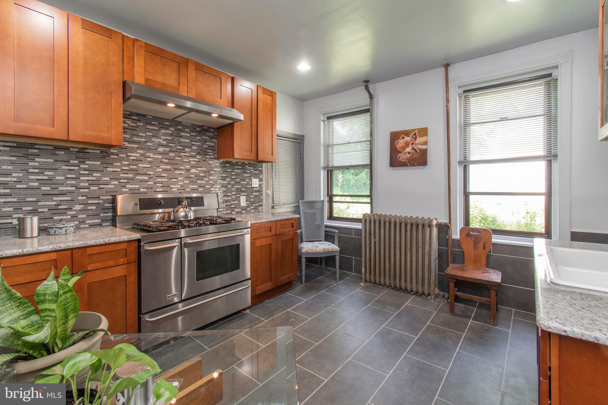 Germantown East literally has 33 homes out of 5000+ with this size interior & acreage. Not only are the kitchen and bath updated, this Victorian twin has main floor laundry hook ups and a 2 car driveway! The wood floors on every level & historic details (original wood banisters, trim & doors; inlay wood flooring, built in bookshelves, decorative fireplaces, wraparound porch and 2 interior stairways) are the perfect backdrop to any customization you desire before or after you move in. The quarter acre lot already feels like it's "off the grid" and is ready for your inner landscape architect to bring it to life for your optimal outdoor lifestyle. Just 1/2 block from local favorites like Germantown Friends School, Uncle Bobby's Coffee & Books and the Germantown Kitchen & Farm Stand. Just a 7 minute walk to Walgreens on the Ave and a 23 minute drive to the Airport or the heart of Center City.