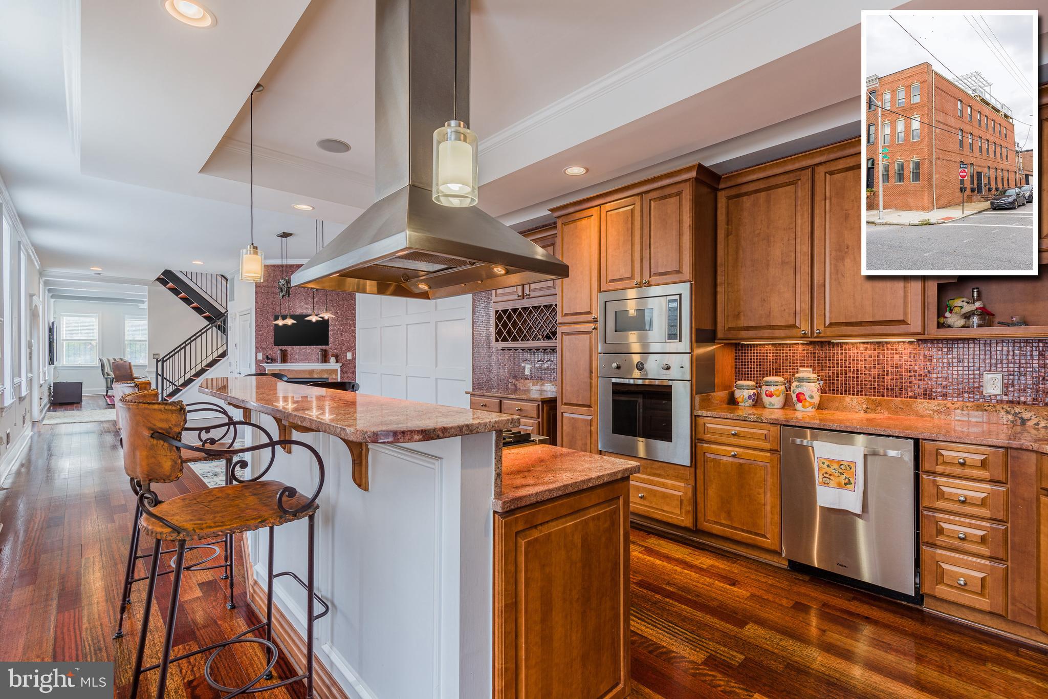 CONTEMPORARY ELEGANCE RADIATES THROUGHOUT THIS EXPANSIVE 4,000+ SQ. FT. GARAGE ROWHOME IN PRIME CANTON LOCATION! This one has it all! Elevator to all 4 levels, whole house speaker system, gleaming hardwood floors throughout the main and upper levels, large room sizes, gourmet island kitchen w/ high end ss appliances, and granite counters. The 2nd level offers 2 large bedrooms and 2 full baths, bedroom level laundry, and rear deck with a privacy fence. The incredible Master suite encompasses the entire 3rd level and features a walk-in closet w/ built-ins, sitting area w/ a wet bar, and luxury spa bath w/ whirlpool tub, and walk-in shower w/ multiple shower heads. There is plenty of room to entertain with 3 levels of outdoor living space including a tiered rooftop deck w/ Pergola and impressive views. Parking is not an issue with the attached 2 car garage. All of this and located in the heart of Canton - this is city living at it's best!