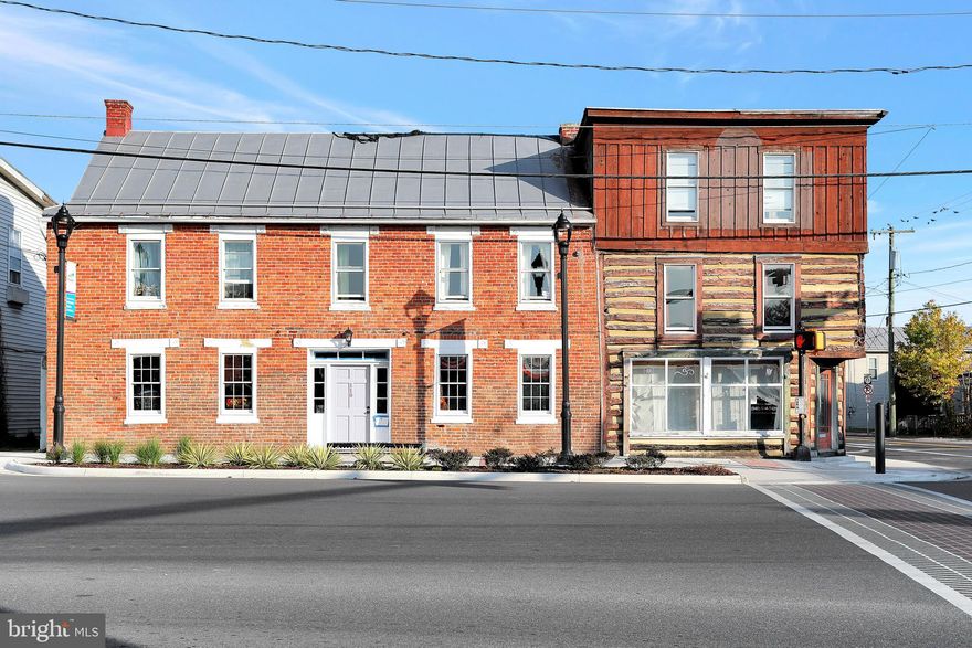 Calling all investors!  5300+ sq ft income producing historic building on a busy corner lot in the heart of Strasburg.  Downstairs features two commercial spaces with lots of charm such as log and brick walls, fireplaces, and beautiful wood floors.  Upstairs there are three apartment units all with central heat and air.  In the first apartment there is one bedroom, one bathroom, kitchen, and a living room with hardwood floors. In the second apartment you will find two bedrooms, one bathroom, kitchen, living room with laminate floors, and hookups for stackable washer/dryer.  The third apartment has one bedroom, one bathroom, kitchen, and a living room with laminate floors.  Excellent location on a main intersection and walking distance to numerous shops and restaurants.  Don't miss this rare opportunity to own a large income producing property!