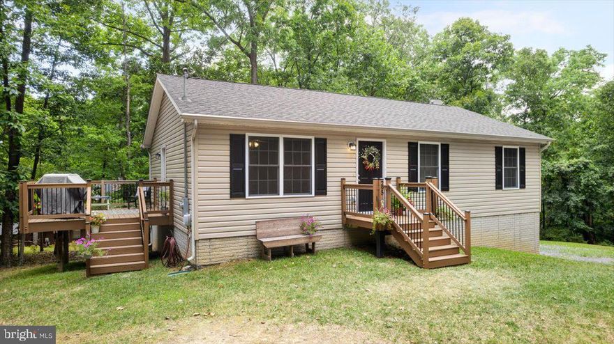 Nestled in the tranquil subdivision of Shannondale, this private and quiet 3-bedroom, 2-bath home offers the perfect blend of comfort and convenience. With 1,176 square feet of living space, this lovely residence is situated on a wooded lot just over half an acre. It features a large primary bedroom, a spacious kitchen, and a beautiful side porch overlooking the forest—perfect for enjoying your morning coffee or unwinding in the evening. Additionally, the home boasts a two-car drywalled garage and an unfinished basement with hookups for a third bathroom, which could be finished out for an additional family room. The home operates on a well and septic system. Located just half a mile from the popular Mountain Lake Club, you'll have easy access to outdoor activities and community events. Agent is Owner.