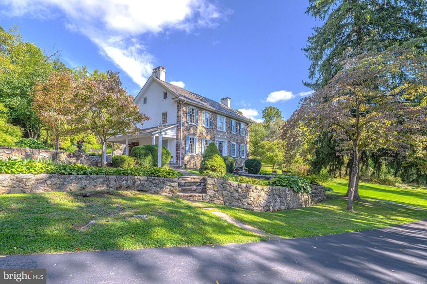 Nestled among twenty private acres of woods, lawns, and gardens, this elegant c1820 stone farmhouse began with just three rooms. Today, this sprawling home of over 4000 s.f. offers the perfect blend of intimate and grand spaces. The formal living room features a wood-burning fireplace, deep window sills, and access to a covered patio. With a beamed ceiling, wide-plank floors, and walk-in fireplace, the dining room is the heart of the home and perfect for festive dinner parties and memorable family gatherings. The library provides a quiet place to relax by the fire with a great book and your favorite drink. The sunny eat-in kitchen and family room are complemented by magnificent views of lush lawns, fruit trees, and perennial flower beds. 4 spacious bedrooms, 4 full & 2 half bathrooms, and 2 offices complete this home's interior. A lovingly-restored bank barn with stables, spring house, smokehouse, garage, and a small stream all add to the charm and beauty of this exceptional property.