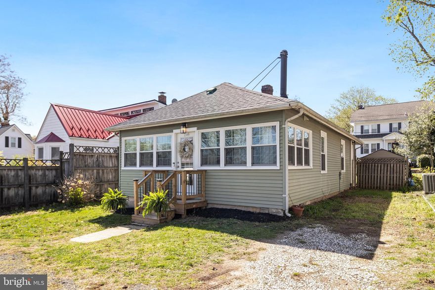 Your dream beach cottage awaits - finished with 2 bedrooms & 1 full bathroom! Nestled in a desirable water-access community, this charming home is just a short stroll from the Chesapeake Bay. Embrace the coastal lifestyle—your perfect getaway for relaxation! Upon entry, you'll step into a bright and versatile sunroom, perfect for an additional lounge area, work from home space, or your Pinterest perfect mudroom. The updated vinyl flooring flows seamlessly throughout the home, complimenting the crisp white color scheme. The kitchen is equipped with a newer washer and dryer for added convenience, while the newly installed wood front steps enhance the home’s curb appeal. Out back, the private, fenced in yard is an ideal space for gardening, entertaining, or unwinding under the stars. Just a short stroll from water access, this home gives charm, comfort, and coastal convenience—ideal for weekend getaways or year-round living!