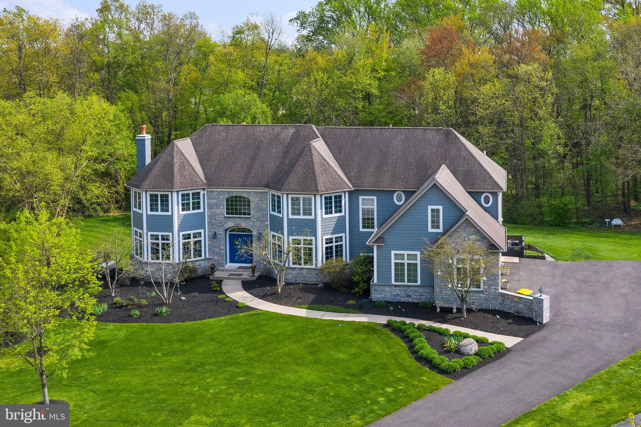 Peace and tranquility await you in this wonderful Blue Bell custom estate home situated at the end of a quiet cul-de-sac in outstanding Wissahickon School District on approx 2 acres. STUCCO-FREE stately stone and Hardie plank exterior welcome you to this never offered 6BR, 5.1BA bright and spacious move in ready home. No detail has been forgotten in this entertainers dream property. Gleaming hardwood floors welcome you into the soaring 2 story foyer flanked by a graceful dining room and cozy living room with gas start wood burning fireplace leading you to a grand gourmet kitchen offering top of the line chefs appliances, over sized pantry and space galore opening to a large and sunny family room with stone hearth and soaring windows. Do you work from home? There is a stately study with spectacular views of your sophisticated landscaped property. Also offered is a convenient mudroom off your oversized 3 car garage, full and half bath. The master suite is roomy and has expansive his and her walk in closets, separate sitting room and a breathtaking master bath overlooking scenic backyard. There are 4 spacious bedrooms and 3 full baths and a large laundry room on 2nd floor as well all with custom closets through out and plenty of storage. The basement is like no other!! It offers an exquisite hand carved bar with stone wall and 4 wine fridges ideal for entertaining, a roomy area for relaxing, a full gym, full bath, bedroom all filled with natural sunlight and sliders to your outdoor oasis with 3 level patio overlooking your open backyard that abuts to scenic woods to offer privacy and spectacular views. This home is ideal for todays lifestyle! Extra features include all new doors, gas start wood burning fireplaces (2), all custom closets throughout, whole house generator, 7 zone sprinkler system, indoor/outdoor speaker system, new furnace/AC offering 4 zones of comfort. Minutes to train, town of Ambler, outstanding schools, parks and Chestnut Hill. OPEN HOUSE Sat 5/22 @ 11am - 1pm