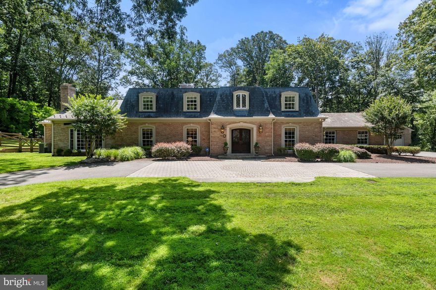 A one-of-a-kind property with a main home plus a pool/guest house, comprised of approximately 7,500 SF, in the highly desirable neighborhood of Potomac Falls!  Perched on 2.05 acres, accessed by a circular drive and located in a low traffic part of the neighborhood near two cul-de-sacs, this Miller-built home is a perfect blend of traditional character and transitional improvements.  You will love special touches the owners have added over the years including raised archway doors; transom windows; architectural moldings; vaulted & coffered ceilings; solid wood, pocket, and White Pine doors; Andersen sliding glass doors; and refinished entry level hardwood floors.  Main level features include a two-story light-filled foyer; spacious living and dining rooms; Gourmet kitchen with Wood-Mode cabinetry; Granite and Corian countertops; Island seating; Viking Professional 6-burner gas cooktop with pop-up down draft; Sub-Zero, Bosch, and GE stainless steel appliances. A magnificent main level addition, by Gilday Renovations, created a custom library with Quarter Sawn White Oak cabinetry & moldings, and an exquisite Primary Bedroom/Spa Bathroom Suite designed for comfort – exceptional dual closets, dual vanities, make-up vanity, steam shower, and heated marble floors just to name a few!  The upper level is home to four additional bedrooms, each with new carpeting, two full bathrooms, and a generously sized, bonus room with endless use possibilities. Rounding out the main home is a lower level with a recreation room, renovated half bath, bonus bath with sink and shower, and a laundry room. Perhaps the most unique aspect of 8801 Bel Air Place is the detached, 1,050 SF pool/guest house, offering a multitude of uses – in-law suite, home office, guest quarters, post-college living, or simply a venue for poolside entertaining. The thoughtfully designed floor plan includes a living room, dining room, renovated breakfast nook, full kitchen, guest room, renovated full bathroom, laundry room, mudroom, new vinyl plank flooring, and its own attached, two-car garage!  
Completing this special property offering are three fireplaces, an inviting pool, an oversized Slateface Paver patio, flat rear green space, mature trees, irrigation system, two-car main house garage, and a parking pad for up to three additional cars.  The home is conveniently located to major commuter routes providing quick access to Washington, DC and Northern VA.  Also, within walking and biking distance is Potomac Village offering a variety of gourmet markets, grocery, restaurant and retail options, and the hidden gem of Great Falls National Park.  This truly is a must see and a very special place to call HOME!