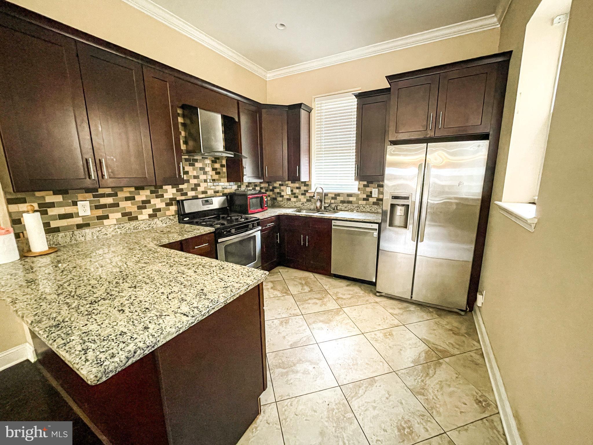 Available August 1! Welcome to 1419 Morris Street, a large 2,200 sqft & stunning 4-bedroom, 2 full & 2 half bath house with 2 outdoor spaces (a patio & roof deck!) Located in a sought-after neighborhood of Point Breeze & right next to Broad Street & the subway, enjoy the diverse culinary scene with renowned restaurants and trendy cafes just steps away. Each bedroom comes with ample closet space & the house has a large fully finished basement with half bath for added room/storage. Updated kitchen with separate dining & living room spaces along with half bath on the 1st floor. The next floor up has 2 bedrooms, laundry, & full bathroom with double vanity. On the top floor you'll find another 2 large bedrooms with updated bathroom & tub with jets. Also access your own private roof deck with unobstructed views! Schedule you showing today!