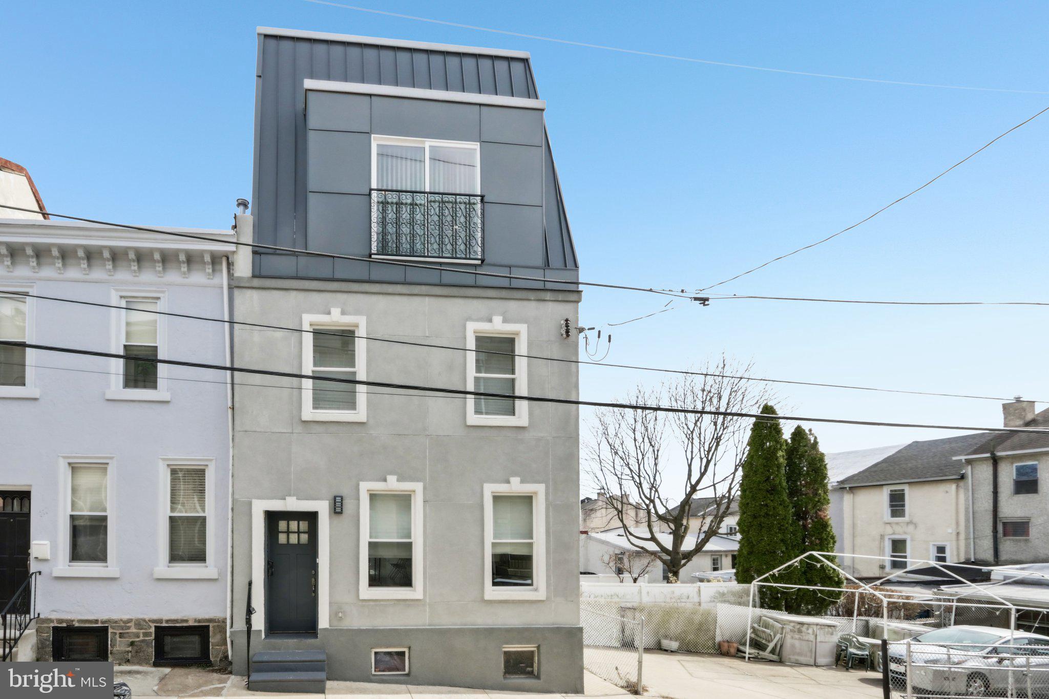 Welcome to this beautifully renovated, nearly new construction end-of-row home. This home rests on a quiet block with only local traffic in the highly desirable neighborhood of Manayunk, a superior vantage point offering panoramic views overlooking the city skyline and western suburbs. With eight years remaining on the tax abatement, this home was meticulously rebuilt, keeping the front and side walls, offering modern living while maintaining the charm of the area. As you enter, you are greeted by a spacious, open-concept main level with gleaming hardwood floors. The living room flows effortlessly into the dining room, which then leads into a chef’s dream kitchen. This kitchen features crisp white tiled floors, an oversized center island with seating, granite countertops, stainless steel appliances, a double wall oven, and a gas range, making it perfect for everyday cooking and entertaining. Sliding doors open to a serene, shaded rear deck with access to the front of the home through a private walkway, providing a peaceful outdoor space. The second level features two enormous bedrooms, each with hardwood floors, and one with a Juliette balcony, offering ample space and natural light. These bedrooms share a full hall bathroom with a tiled tub/shower combo. Conveniently, the laundry room is also located on this level, making chores a breeze. On the third level, you’ll discover two more generously sized bedrooms, both with hardwood floors and Juliette balconies, including the grand primary suite. This sanctuary boasts two walls of windows that flood the room with light, a spacious walk-in closet, and a luxurious ensuite bathroom with a dual vanity and a seamless walk-in shower. The second bedroom on this level is also large and is serviced by a full hall bathroom featuring a soaking tub and a stall shower. The home’s crowning feature is the rooftop terrace with stunning views of the Schuylkill River, offering a serene retreat to enjoy morning sunrises or evening sunsets. The partially finished basement is perfect for additional storage or can easily be transformed into additional living space to suit your needs. Luxury features include dual-zone climate controls with two central air cooling systems, a French Mansard-style roof, and original 12-inch-thick walls that ensure energy-efficient temperature control and a quiet, private haven. Located just blocks from the vibrant Pretzel Park, the bustling shops, cafes, restaurants, and bars of Main Street in downtown Manayunk, several supermarkets, a SEPTA regional train station, and close to the Schuylkill River Trail spanning 30+ miles from Center City to Valley Forge National Park, this home places you right in the heart of everything the neighborhood has to offer. Don’t miss your opportunity to make this stunning property your own!