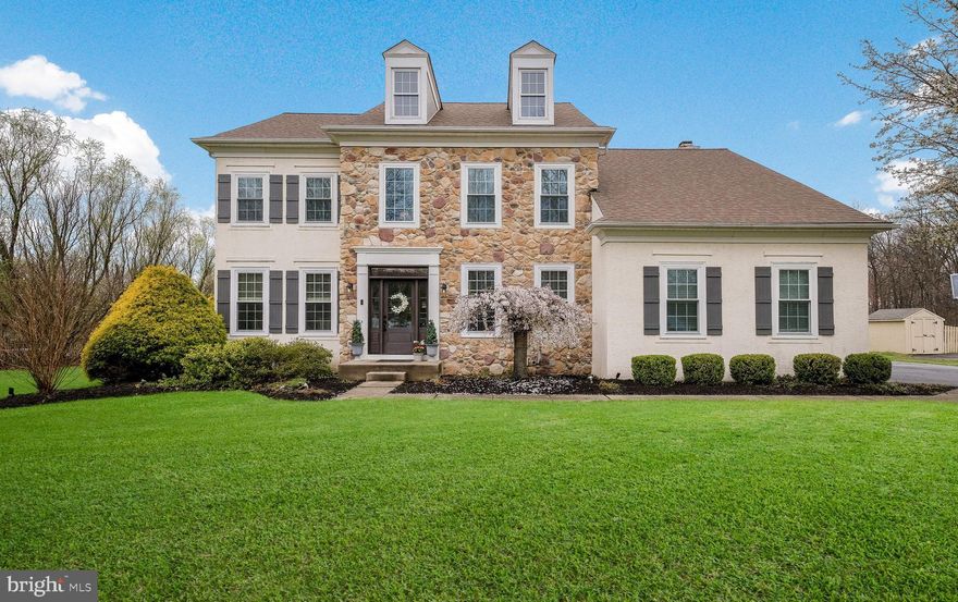 Move right in to this impeccably maintained and tastefully updated center-hall colonial on a premium lot in a sought-after, family-friendly neighborhood. This single-owner home, with over $250,000 of quality upgrades, sits on a private cul-de-sac and boasts a thoughtfully-designed floor plan ideal for everyday comfort and gracious entertaining. The interior radiates sophistication with custom wainscoting, volume ceilings and upgrades throughout. The private study features handcrafted built-ins; the sunroom showcases a gas fireplace and antique beams; and the family room is highlighted with a floor-to-ceiling, double-height, stone wood-burning fireplace flanked by built-in shelving. The formal living and dining rooms provide adaptable bonus space for welcoming guests, curling up with a book, or hosting holiday dinners. The centrally-located kitchen boasts a custom island and newer stainless steel appliances including a Bosch smart dishwasher and GE smart gas range. Upstairs, the spacious master bedroom features a volume ceiling, double closets and a renovated en-suite bathroom with a large shower, multiple shower heads, soaking tub, and radiant in-floor heat. Three additional bedrooms and a hall bath with dual vanities graciously accommodate guests or your growing family. The partially finished basement is built for fun! A tv viewing lounge, wet bar, half bath and shuffleboard table encourage memory-making gatherings. A French drain and sump pump with battery back-up ensure peace of mind. The exterior boasts professional landscaping and a large paver patio with a 30,000 gallon in-ground heated pool with rock waterfall and spa. Roast s’mores at the built-in fire pit or cozy up to the bar at the outdoor tavern while you enjoy beautiful sunsets or family movie night. Close to shopping, parks, restaurants, churches and schools, this home has it all! Experience the exceptional charm of this Bucks County gem for yourself by scheduling an appointment today!