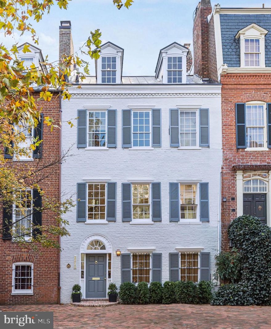 EXQUISITE, BRAND-NEW RENOVATION WITH TWO CAR PARKING by RG Custom Builders turned this historic row house into a modern marvel! Located on one of the most prestigious blocks in Georgetown’s West Village with 2 car parking and a historic façade; every inch of this historic home has been meticulously rebuilt to create a cohesive flow amongst its living spaces. This 4-level residence is approximately 4,178 square feet and features high coffered ceilings, white oak flooring, a gourmet Kitchen with Quartz countertops, Shiloh inset custom cabinetry and top-of-the-line appliances, including a gorgeous Ilve range. Entry level opens into a gracious formal Library with gas fireplace and beautiful herringbone floors, followed by a convenient Mudroom as well as Bedroom that can double as a Home Gym or an Office. The second level features a large-scale formal Living Room with 9+ foot soaring ceilings, gas fireplace with Dreamcast Artisan Concrete Mantel and oversized historic windows. The open plan chef’s Kitchen allows for perfect flow into the sun-filled Breakfast Room with pantry wall. The formal Dining Room includes triple exposures, wet bar and custom wall moldings. This level also offers walkout access into the beautiful rear garden with fresh flagstone hardscape and a custom teak arched garden door leading to 2 SUV-sized parking spaces. The spacious third floor features a generous Primary Bedroom Suite with double closets and oversized marble bathroom, reflecting a modern interpretation of classic Georgetown design. This level also includes the 2nd Bedroom and 3rd Bedroom both with en-suite Bathrooms. The top floor features the 4th Bedroom which can double as a secondary Primary Suite, in addition to the 5th Bedroom, perfect as a Guest Bedroom / Home Office / Den. Every inch of this immaculate home has been thoughtfully redesigned for modern living while honoring its Georgetown heritage. OPEN HOUSE SUNDAY, 3/24 FROM 2-4PM!