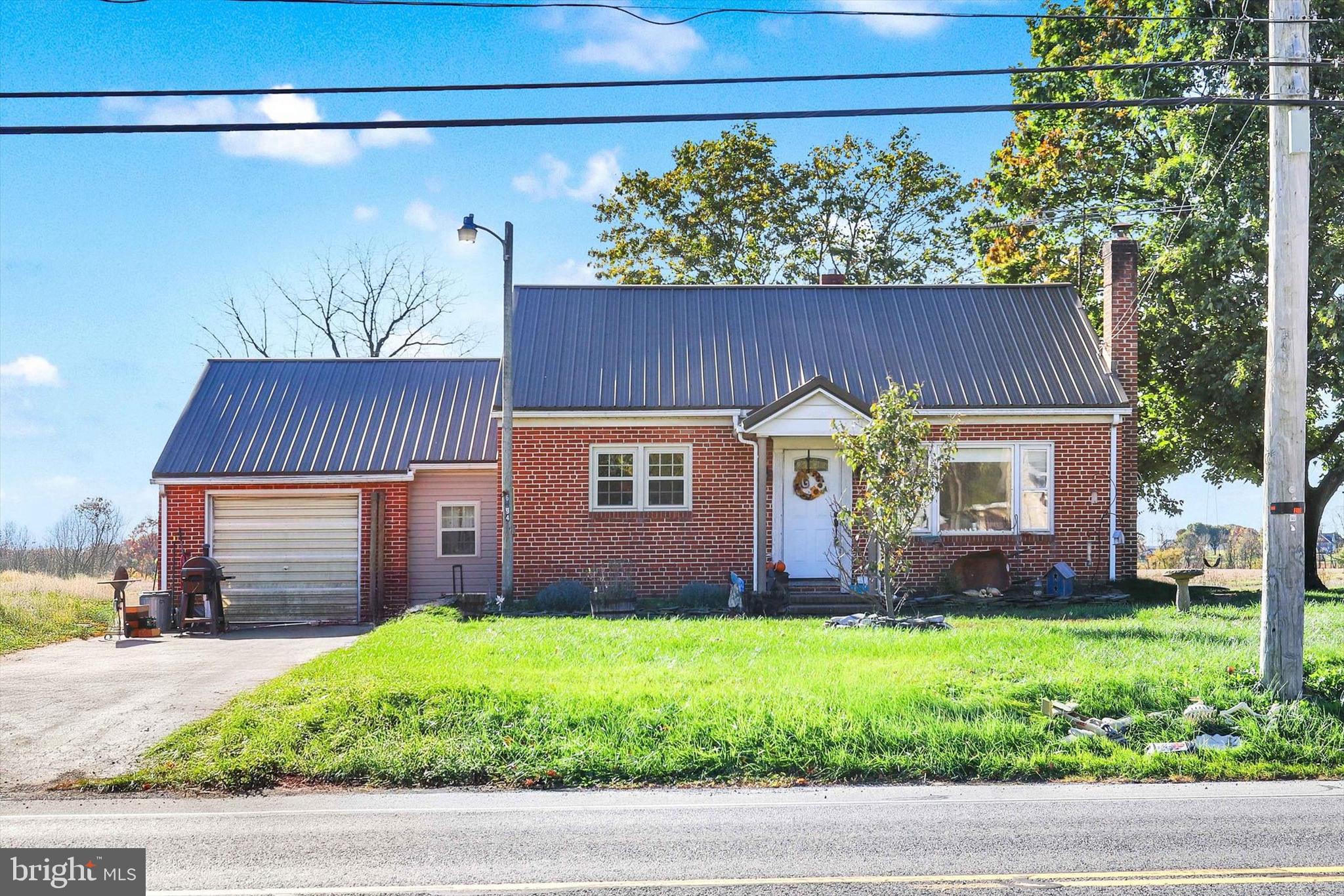 Take in the countryside surrounding this charming all brick home.  On the main level this home offers a large living room leading into an eat in kitchen. Walk through the kitchen and you can exit through the mudroom to the attached garage. Past the living room towards the back of the home you will find two bedrooms and a full bath. Original hardwood floors run through most of the main level and Luxury Vinyl plank has been installed in the mud room. Upstairs has been finished into another bedroom with a large walk in closet and storage area. Recent updates include Heating and Air, a metal roof, and a finished mudroom. This home is move in ready and ready for you to make it your own. Located just minutes from Chambersburg shopping, churches, restaurants, parks, hospital, downtown and more!