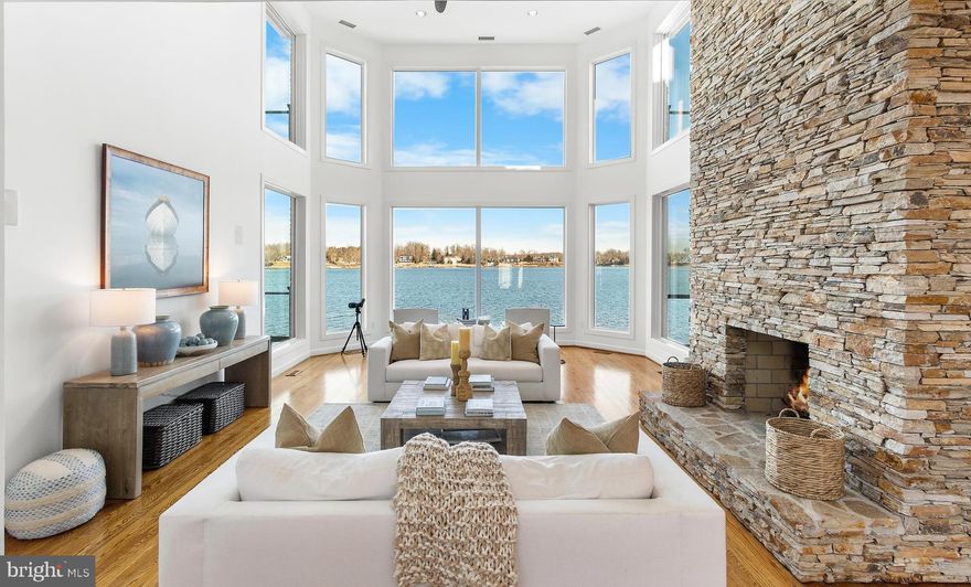 Welcome to the coveted South River Landing waterfront community. This remarkable waterfront residence showcases sweeping panoramic river views with more than 180 degrees of open water frontage. Thoughtfully designed to maximize the scenery, expansive windows frame the ever-changing views, bringing vibrant sunrises, glowing sunsets, and shimmering moonlit reflections into everyday living. 

This stately all-brick home offers approximately 5,000 square feet with 5 bedrooms, 4. 5 bath, all thoughtfully curated with timeless materials throughout. Sweeping water vistas take center stage, seamlessly woven into the design so the river serves as a stunning backdrop to nearly every room. The focal point of the main level is the dramatic two-story living room featuring soaring windows and a striking two-sided stone fireplace. The main level also includes a waterfront primary suite with private deck access, spa-inspired bath, and spacious walk-in closet, providing comfort and convenience for main-level living.

The beautifully remodeled kitchen serves as the centerpiece of the home, featuring custom cabinetry, premium appliances including dual wall ovens, 48-inch refrigerator, cooktop, built-in microwave, and generous prep space designed for both entertaining and daily living. The kitchen opens seamlessly to a screened porch overlooking the river, creating a stunning setting for indoor-outdoor dining and relaxation. A well-appointed laundry room, powder room, and oversized two-car garage complete the main level.

Upstairs, a versatile office or guest suite offers built-ins and a private waterfront deck, while an additional spacious suite features vaulted ceilings, fireplace, large walk-in closet, private waterside deck, and luxurious bath capturing serene river views.

The walk-out lower level is ideal for entertaining, featuring a custom bar with high-end appliances, expansive recreation areas, wood-burning fireplace, two additional bedrooms, and two full baths. Floor-to-ceiling windows and dual patios provide seamless access to outdoor living along the water’s edge.

Located within the gated waterfront community of South River Landing, residents enjoy resort-style amenities including 24-hour staffed security, a waterfront pool, deep-water marina, kayak launch, tennis courts, playground, basketball court, private beach, and scenic walking trails. Conveniently located near Annapolis with easy access to Washington, D.C. and Baltimore, this home offers an exceptional blend of privacy, luxury, and waterfront lifestyle. Welcome Home!