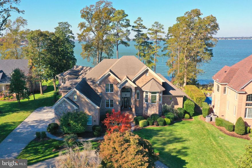 Opportunity knocks, priced  below appraisal!  Just in time for fun on the water!  Waterfront perfection with breathtaking panoramic views of the scenic Nansemond River.  Ideally situated on a premiere lot designed to maximize the majestic scenery in coveted The Riverfront at Harbour View .  Upon entering the two and a half level foyer you are greeted by panoramic water views from floor to ceiling windows. Custom built for the current owners by acclaimed Eric Sasser Construction, this almost 7,000 sq. ft home, boasts 6+ bedrooms, 4 full and 2 half baths with exceptional attention to detail throughout.  

Entertain in style and ease from the open concept gourmet kitchen with island and large eat-in dining area with stellar views. The kitchen flows into the formal living room with a handsome stone fireplace (gas) and formal dining room with lots of light perfect for large gatherings.  A spacious Great room features floor to ceiling windows providing breathtaking water views and a soaring stone fireplace (gas) creating a captivating focal point.  The large screened in patio off the gourmet kitchen is perfect for dining al fresco and entertaining and has been customized with electric storm shutters. The main level of this home further extends to two primary suites on each end of the home  with shower and separate jetted tub in the primary bath and a second primary bedroom suite with stand up shower.  A forward thinking built-in elevator shaft, designed to run from the garage to the main and upper levels of the home, is installation ready.  A versatile library, study or home office is located mid level up the impressive side hall staircase. 

The expansive upper level of the home features four bedrooms, two full baths and one half  bath, a separate steam room/spa and a large recreation or sitting area with french doors opening to a spacious terrace featuring more fantastic water views.  Re-enact your most beloved operas and theater from the interior half moon "Juliet" balcony overlooking the main level great room and a picturesque view the the Nansemond River.  Large studio or home office is located mid level and accessible through the upper level, main level or a private side entrance.   Plenty of storage, closets and custom built-ins throughout home.  Walk-up stairs to unfinished attic.  Multi-zone top of the line HVAC system is four years young. 

Fully landscaped backyard features a porch, brick terrace, fire pit and fenced elevated spa area for relaxing while watching the activities and wildlife on the Nansemond river.  Step out onto the upper terrace or stroll down the brick walking paths to the illuminated pier to experience spectacular sunsets and photograph majestic native waterfowl and dolphins swimming in the river.  Other features of this home include a circular driveway and side loading three car garage with access to the elevator shaft, kitchen and private office/loft.  
An expansive pier with built-in benches, a fish cleaning area and a boathouse with hydraulic boat lift rounds out this fantastic property.  Come for the views and sunsets and invest in your quality of life!

The award winning Riverfront at Harbour View community is a lifestyle.  

Located in the heart of Hampton Roads, fifteen minutes from Downtown Norfolk and the Peninsula.  Community amenities include an 18-hole championship golf course (additional membership available), two pools, two fantastic clubhouses, an amphitheater and walking trails. Great local eateries and shopping options abound within walking or biking distance.