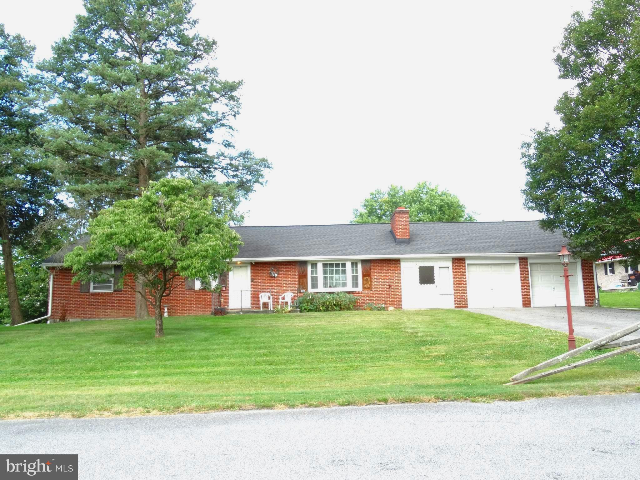 Welcome to Madison Ave!! All brick rancher in Hamilton Township. Walking in the front door that leads to the spacious living room with original hardwood flooring and a brick fireplace. The woodstove insert will convey. The open, well lit dining area has hard wood flooring and a hand made wooden corner cupboard. The kitchen sports plenty of counter tops and cabinets, also included are the refrigerator and gas range & oven. Laundry room off of the kitchen, close to the back door. Washer and Dryer convey. Three bedrooms with original hard wood flooring. Oversized 2 car garage with a 31 x 22 workshop addition that is also bricked. Work benches stay. Full basement. A brand new 200 amp panel box installed. A brand new water proofing system has been installed with transferable lifetime guarantee.