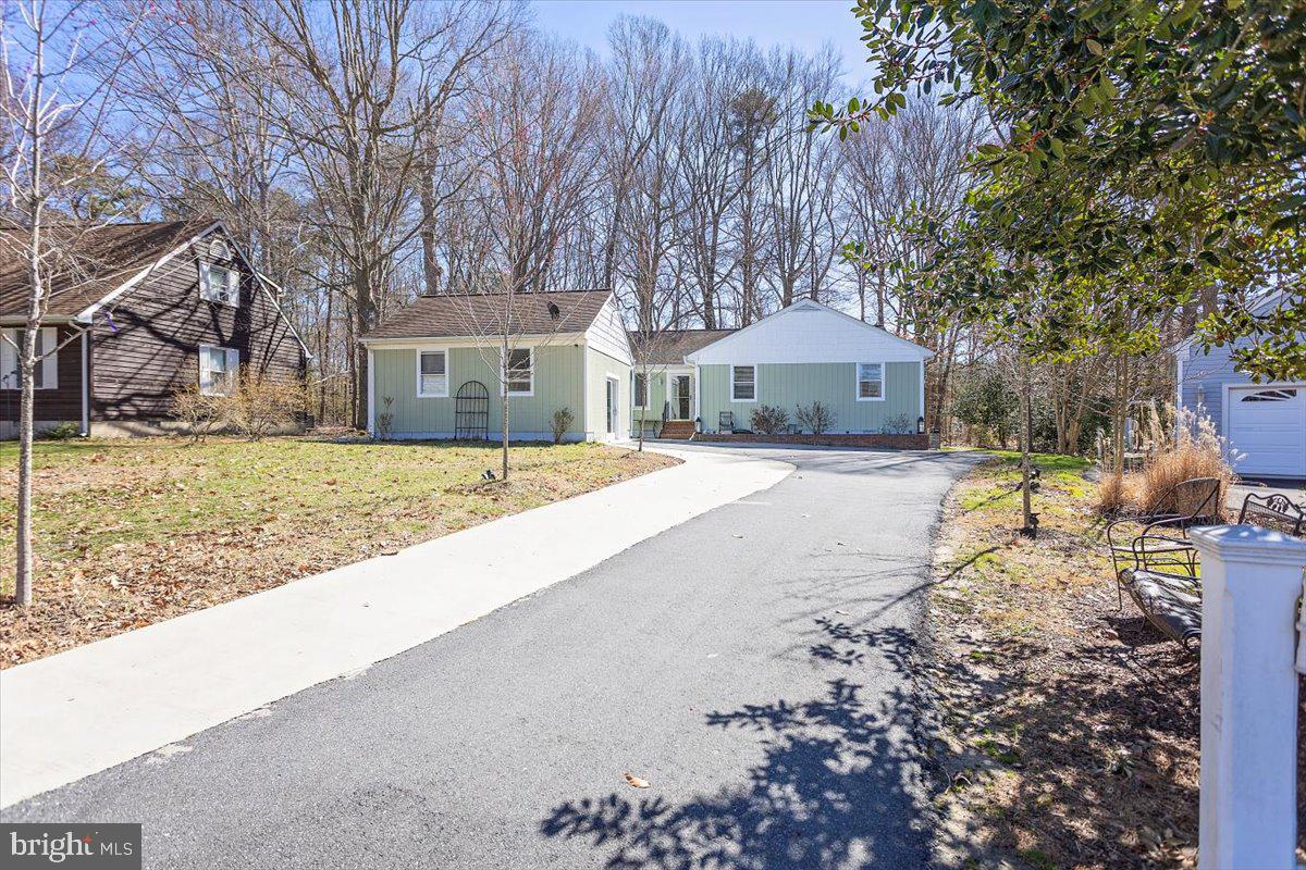 Welcome to 29285 Pin Oak Way at South Beechwood! If you are tired of the cookie cutter homes and are looking for a home with character, space and subtle uniqueness, then this is the home for you! This home was largely remodeled in 2019 and is key-turn ready! Featuring four bedrooms, 2.5 bathrooms, a dreamy kitchen and a substantially sized paved driveway, this home is move-in ready! This home has a large deck that wraps around the back of the house and provides a remarkable view of the backyard and woods. The dining room, owners ensuite and a bedroom have direct access to the deck. The attached two car garage was converted into living space and can be used a bonus room or family room. There is also a finished shed in the backyard that can be used as a studio or gym. The backyard has a storage shed and a small patio off of the deck for your grill or fire pit. This neighborhood does not have an HOA , quick access to RT 50, within a few minutes drive to downtown Easton, shopping and schools.
Buyer to verify square footage.