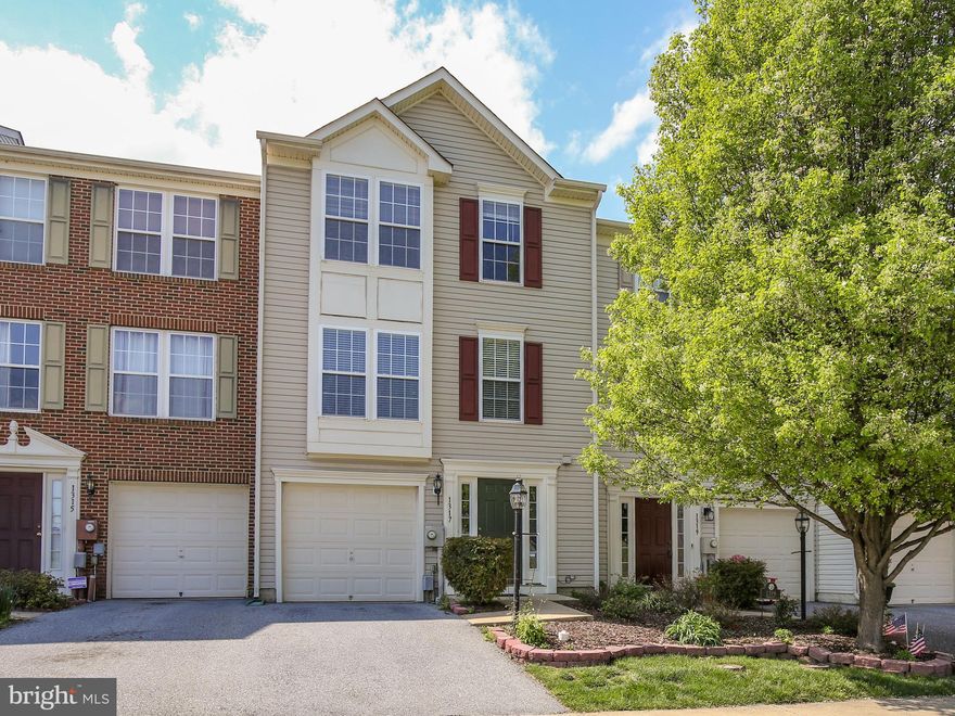 3-story finished garage townhome in a great walkable neighborhood with playgrounds. Close to shopping, grocery, restaurants and minutes to major commuter routes. Three finished levels with laundry room, bonus/family room, additional bump-out, half-bath and backyard access on the ground entry level. Gorgeous hardwood floors in the kitchen, breakfast room, and additional dining area/bump-out. Spacious family room with plush carpeting and great natural light. On the upper level is the Owner's Suite with a vaulted ceiling , walk-in closets and en-suite bath featuring dual sinks, separate shower and soaking tub. Two more bedrooms and full bath finish off this level. This townhome sits on a level lot with a gorgeous mature tree and landscaping out front as well as plentiful green grass out back. Don't miss out on this commuter friendly, garage-unit townhome in Fairfax Crossing! ***Property was appraised at a total of 2,042 square foot of total living space when built.