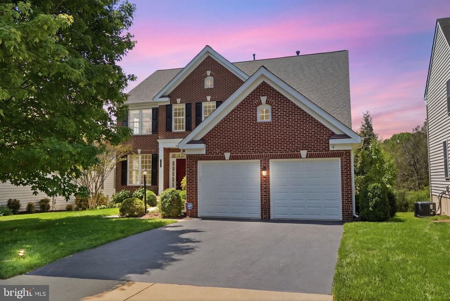 This beautiful brick-front colonial is tucked away on a premium lot in the quaint community of **Innisbrooke**, which offers a wonderfully low-cost HOA. The home welcomes you with an inviting main level featuring gorgeous hardwood floors, nearly all of which have been freshly refinished (2026). You’ll find classic living and dining rooms alongside a dedicated home office, while the light-filled two-story extended family room features a wall of windows that flows into a gourmet kitchen complete with a granite island, custom backsplash, and a brand-new cooktop (2026). Just off the kitchen, the backyard transition is seamless, offering a new low-maintenance Trex deck (2024) and a screened gazebo that backs to peaceful, lush green trees—the perfect spot to relax on Merlot Court and enjoy a glass of your favorite vintage. Warm, custom lighting has been thoughtfully added throughout, perfectly highlighting the professional paint refresh completed across the majority of the home (2025/2026). Since 2022, the property has been meticulously cared for with high-value updates including a new roof with a lifetime shingle warranty (2026), a high-efficiency gas water heater (2022), and a premium air quality system with a whole-home Aprilaire humidifier and HVAC UV light (2025). For those who love to host, the extensive hardscaping and professional landscaping include a gorgeous patio framed by mature crepe myrtle trees and dramatic uplighting for al fresco sunset entertaining. Upstairs, you will find four spacious bedrooms, including a primary suite with dual walk-in closets, a second bedroom with its own private ensuite bathroom, and two additional bedrooms joined by a convenient Jack and Jill bath. The fully finished walk-out basement serves as a fantastic retreat for guests or multi-generational living, featuring the fifth bedroom with a full bathroom nearby, along with a conveyable pool table and dart board. Fitness enthusiasts will love the professional-grade gym equipment that conveys, including a PRx Profile Pro squat rack with pull-up bar, bench, barbell, weight storage, dip station, bumper plates, and change weights. With additional refrigerators in both the garage and the basement, cold beverages are never far away. Modern conveniences abound with a professionally sealed driveway (2026), an updated six-zone irrigation system, eight Blink cameras, and a comprehensive alarm system, all while being moments away from vibrant shopping, dining, and lodging with seamless commuter access via the VRE, bus lines, and the Metro. Professional photos, 3D walkthrough, floor plans, and Matterport on listing by 5/6/26.