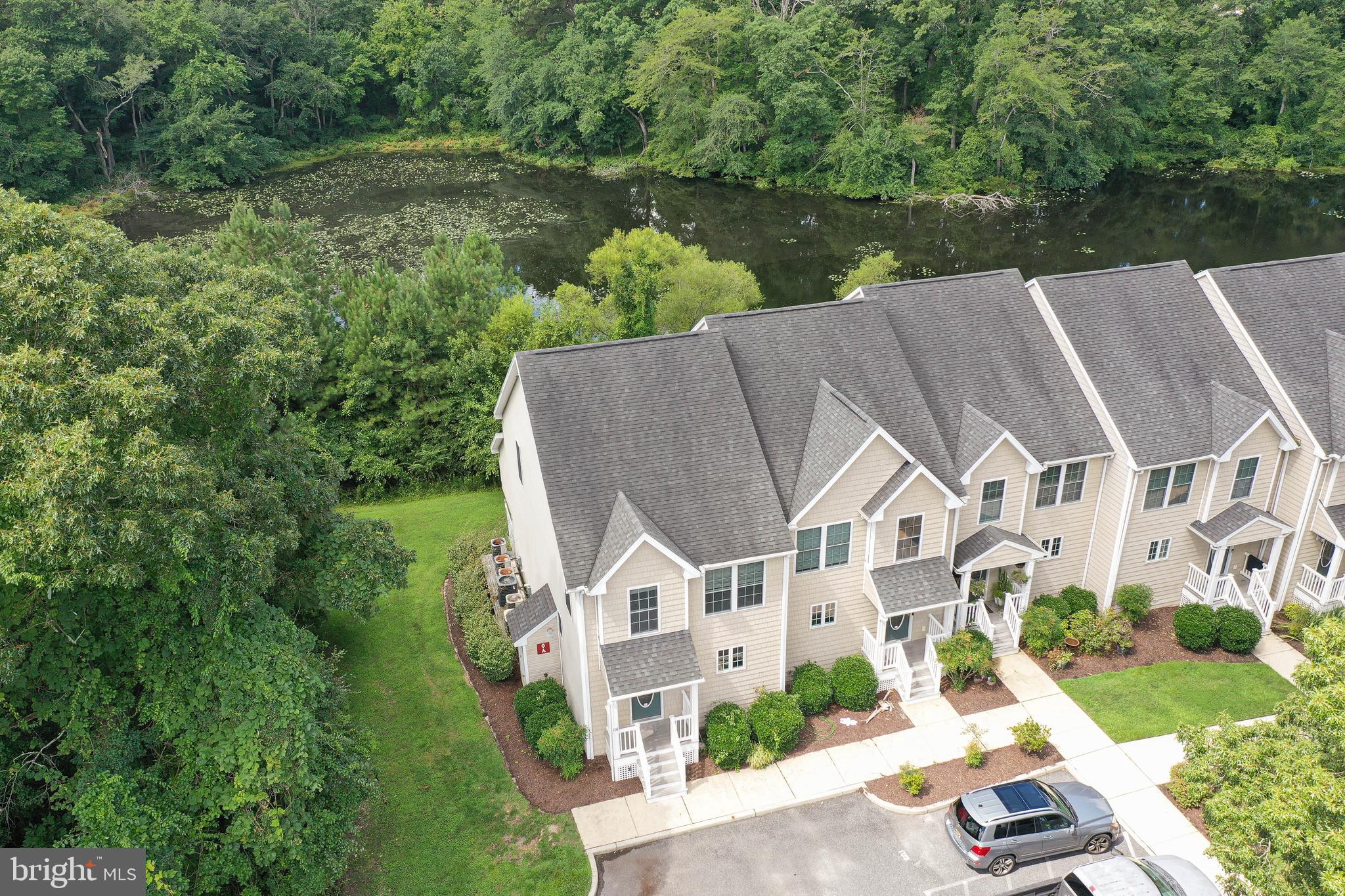 Carefree living at its finest! Spacious end-unit townhome offers much more than meets the eye from its welcoming exterior - 3BR, 3.5BA, 2692sf of well-designed living space. * * * Maintenance-free lifestyle - for $267/mo the COA covers lawn maintenance, common area maintenance, water, sewer, trash, insurance, and snow removal - Giving you the freedom and peace of mind only a condo association can offer! * * * Built in 2006, by a local, luxury homebuilder, and updated in 2022 with New HVAC units, new appliances, new sliding doors, new paint, and new flooring. Convenience of instant hot water and central vacuum. Wide open floorplan with a bright and roomy kitchen - granite counters, breakfast bar, tile floor. Durable and handsome LVP flooring, and crown-molding throughout the dining, living, and sunroom. Ample dining area opens into the living room with built-in entertainment area, and through to the sunroom. Sliding door leads to your main balcony featuring maintenance-free materials, and gorgeous views of the trees - relax and unwind or enjoy dinner alfresco listening to the birds. A half bath, and coat closet complete the main floor. Through a glass-paned door, are the stairs to the lower level, an amazing space featuring built-in cabinetry and granite countertop, ceiling fans, tons of storage, a full bath w/tile floors, step-in shower. Would make a great guest suite! Walk-out to your covered patio - enjoy the shade or lounge in the lush grass. The upper floor houses the owner's bedroom - double-closets, full, en-suite bath w/tile floor, step-in shower - private balcony looking into the tree tops - your own treehouse! Two additional bedrooms, a 3rd full bath - tile floors, tub/shower combo, and laundry room with washer + dryer, complete this level. Incredible location - close to shopping, dining, and events at the University and Downtown Salisbury, but tucked away on a no-through street in Waterside Landing, on a lovely lot backing to trees surrounding the pond. Sizes, taxes are approximate.