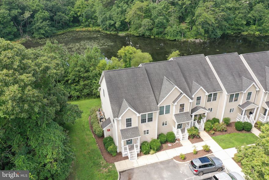 Carefree living at its finest! Spacious end-unit townhome offers much more than meets the eye from its welcoming exterior - 3BR, 3.5BA, 2692sf of well-designed living space. * * * Maintenance-free lifestyle - for $267/mo the COA covers lawn maintenance, common area maintenance, water, sewer, trash, insurance, and snow removal - Giving you the freedom and peace of mind only a condo association can offer! * * * Built in 2006, by a local, luxury homebuilder, and updated in 2022 with New HVAC units, new appliances, new sliding doors, new paint, and new flooring. Convenience of instant hot water and central vacuum. Wide open floorplan with a bright and roomy kitchen - granite counters, breakfast bar, tile floor. Durable and handsome LVP flooring, and crown-molding throughout the dining, living, and sunroom. Ample dining area opens into the living room with built-in entertainment area, and through to the sunroom. Sliding door leads to your main balcony featuring maintenance-free materials, and gorgeous views of the trees - relax and unwind or enjoy dinner alfresco listening to the birds. A half bath, and coat closet complete the main floor. Through a glass-paned door, are the stairs to the lower level, an amazing space featuring built-in cabinetry and granite countertop, ceiling fans, tons of storage, a full bath w/tile floors, step-in shower. Would make a great guest suite! Walk-out to your covered patio - enjoy the shade or lounge in the lush grass. The upper floor houses the owner's bedroom - double-closets, full, en-suite bath w/tile floor, step-in shower - private balcony looking into the tree tops - your own treehouse!  Two additional bedrooms, a 3rd full bath - tile floors, tub/shower combo, and laundry room with washer + dryer, complete this level. Incredible location - close to shopping, dining, and events at the University and Downtown Salisbury, but tucked away on a no-through street in Waterside Landing, on a lovely lot backing to trees surrounding the pond.  Sizes, taxes are approximate.