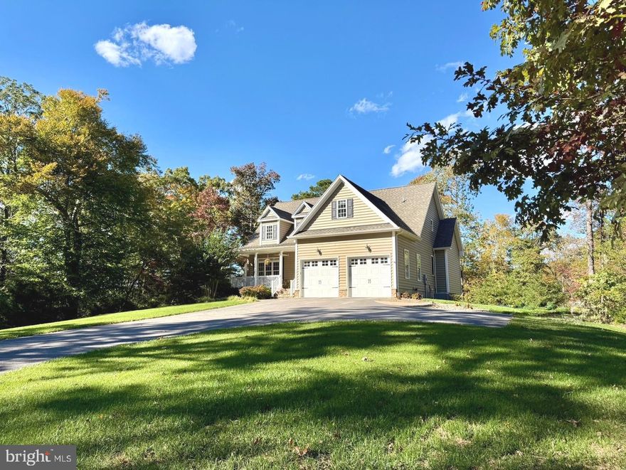 Beautifully maintained custom Cape Cod set on a private one-acre lot close to Myrtle Point Park. The main level features hardwood floors and a bright great room with high ceilings, skylights, and abundant natural light. The main-level primary suite with a full bath for added convenience.  Kitchen has  cherry cabinets, granite counters, stainless steel appliances, and a gas stove.

Upstairs offers two spacious bedrooms, a full bath, and a versatile bonus room perfect for a craft or sewing room. The fully finished lower level serves as an in-law suite with a kitchen, full bath, fourth bedroom, dining area, game room, and walkout access to the patio.

Additional highlights include dual-zone HVAC, a fenced backyard, lawn sprinkler system, and attractive landscaping. Enjoy outdoor living with a welcoming front porch, a back deck with a gas line for grilling, and a lower patio featuring a built-in fire pit. Conveniently located near Solomons Island, PAX River, shopping, and restaurants.