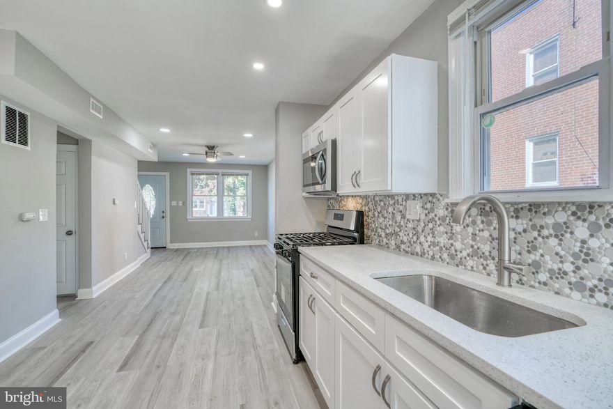 Completely Renovated Semi Detached Home, so Elegant ! Open Layout, All new Kitchen with Stainless Appliances, Quartz Countertop, Coordinating Tile Backsplash, Wood Shaker Cabinets. Upstairs Bathroom features Custom Tilework, Designer Fixtures, and Designer Lighting. Basement Suite includes 3rd Bedroom and Private Full Bathroom with Custom Tilework and Designer Gold colored Fixtures. New Flooring and Carpet, Good sized bedrooms, New HVAC, Front Porch, Driveway. Replacement Windows, Cool Lighting. You will Love this Home!