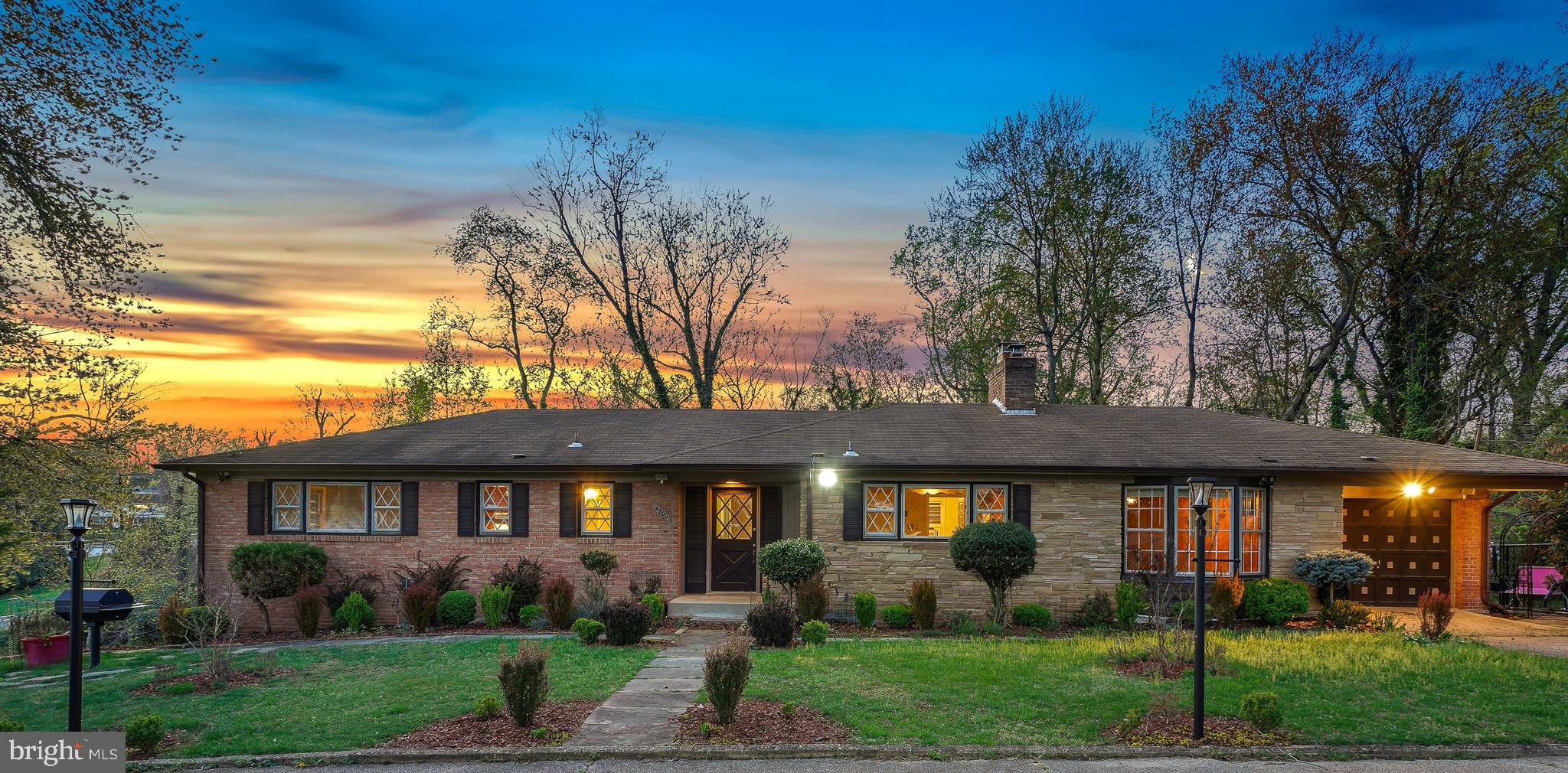 A substantial price adjustment on this solid brick mid-century rambler! Situated on an incredible, picturesque 1.74-acre lot, this charming home offers the convenience of one-level living on an extraordinary property surrounded by lush greenery. Built in 1961, this spacious three-bedroom, two full-bath, and two half-bath home boasts exceptional flow, beautiful brick accents, and practical living spaces.
The inviting living room features a brick fireplace, wood beam ceilings, and sliding doors that open to the backyard. The large eat-in kitchen is equipped with a stainless steel appliance suite, a center island, a breakfast bar, a beamed ceiling, and ample prep space. Adjacent to the kitchen, the formal dining room features French doors leading to an office/family room.
The bedroom wing includes three well-proportioned bedrooms with wood flooring and two full bathrooms, including a primary suite. The primary bedroom offers a walk-in closet with an organizing system and a private full bath.
The lower level provides additional living space, including a large recreation room with a fireplace and bar area, a bonus room, a half bathroom, a cedar closet, a laundry room, and incredible storage with potential for further customization.
The exterior includes a convenient carport and an expansive 76,136 sq. ft. lot with mature trees, backing to a stream. This idyllic setting offers peace and serenity, with easy access to I-495 and just 1.2 miles to the Green Line Metro station. Nearby amenities include Woodberry Forest Recreation Center and Henson Creek Park.