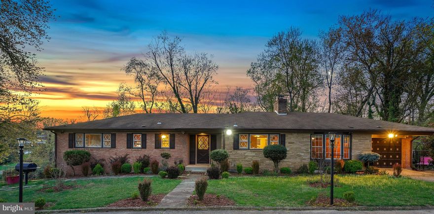 A substantial price adjustment on this solid brick mid-century rambler! Situated on an incredible, picturesque 1.74-acre lot, this charming home offers the convenience of one-level living on an extraordinary property surrounded by lush greenery. Built in 1961, this spacious three-bedroom, two full-bath, and two half-bath home boasts exceptional flow, beautiful brick accents, and practical living spaces.

The inviting living room features a brick fireplace, wood beam ceilings, and sliding doors that open to the backyard. The large eat-in kitchen is equipped with a stainless steel appliance suite, a center island, a breakfast bar, a beamed ceiling, and ample prep space. Adjacent to the kitchen, the formal dining room features French doors leading to an office/family room.

The bedroom wing includes three well-proportioned bedrooms with wood flooring and two full bathrooms, including a primary suite. The primary bedroom offers a walk-in closet with an organizing system and a private full bath.

The lower level provides additional living space, including a large recreation room with a fireplace and bar area, a bonus room, a half bathroom, a cedar closet, a laundry room, and incredible storage with potential for further customization.

The exterior includes a convenient carport and an expansive 76,136 sq. ft. lot with mature trees, backing to a stream. This idyllic setting offers peace and serenity, with easy access to I-495 and just 1.2 miles to the Green Line Metro station. Nearby amenities include Woodberry Forest Recreation Center and Henson Creek Park.