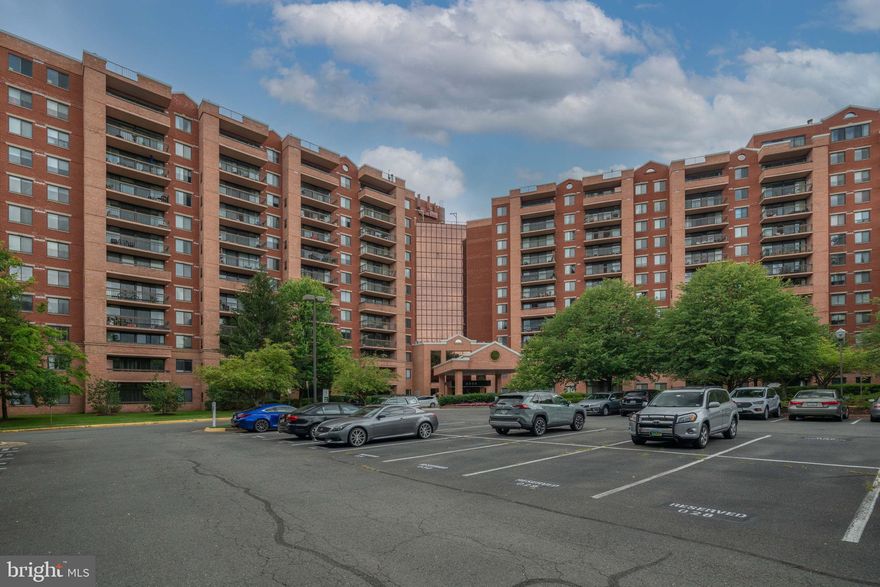 WOW-this is how you want to live – a resort feel in a beautiful, quiet setting. Gorgeous corner end unit with soaring 10ft ceilings located on the quiet side of the building. Gourmet kitchen with cherry cabinets, granite counters, undercabinet lighting, upgraded tile flooring and room for a quaint table. Lovely open floor plan with combination dining/living room. A quiet balcony off the living space allows you to enjoy your morning coffee or evening beverage in privacy and a view of lovely greenery. The primary bedroom is spacious and features a walk-in closet with custom shelving and a peaceful primary bathroom. There is a second quiet balcony off the bedroom to relax with a good book or just listen to the nature surrounding you. A second bedroom, guest bath, stackable washer/dryer and spacious walk-in hall entry closet with custom shelving completes the living space. Hand scrubbed, sustainable Eucalyptus hardwoods grace the living and dining area. There is an extra storage space and an assigned parking space included. Electrical has been updated and there is a brand-new hot water heater installed this year. The unit is located near a side door to the parking area with your convenient space just steps away, which is great if you have a pet or need to bring packages in from the car.  And the world-class amenities – don’t get me started!!! There is a 24-Hour front desk attendant, Business Center with high-speed internet, Year-round Pool which is open in the summer and tented during the colder months. Year-round Tennis facility which is also tented in the colder months. Valet Cleaner, florist, and a free shuttle to the West Falls Church Metro station during commute times. 24-hour state-of-the-art Fitness center, Locker rooms with saunas, Club room with billiard table and media area, Private conference room, Bicycle storage room, Controlled-access gated entry, and plenty of guest parking. The complex is located on 21+ wooded acres with walking trails, community grills and picnic area. Location can’t be beat – close to downtown Tyson’s, Falls Church City, minutes to Trader Joe’s, Whole Foods, Wegman's, West Falls Church Metro (building has a shuttle to the metro), close to I66, I495. A well-managed community featuring luxurious living – make this special space your new home.