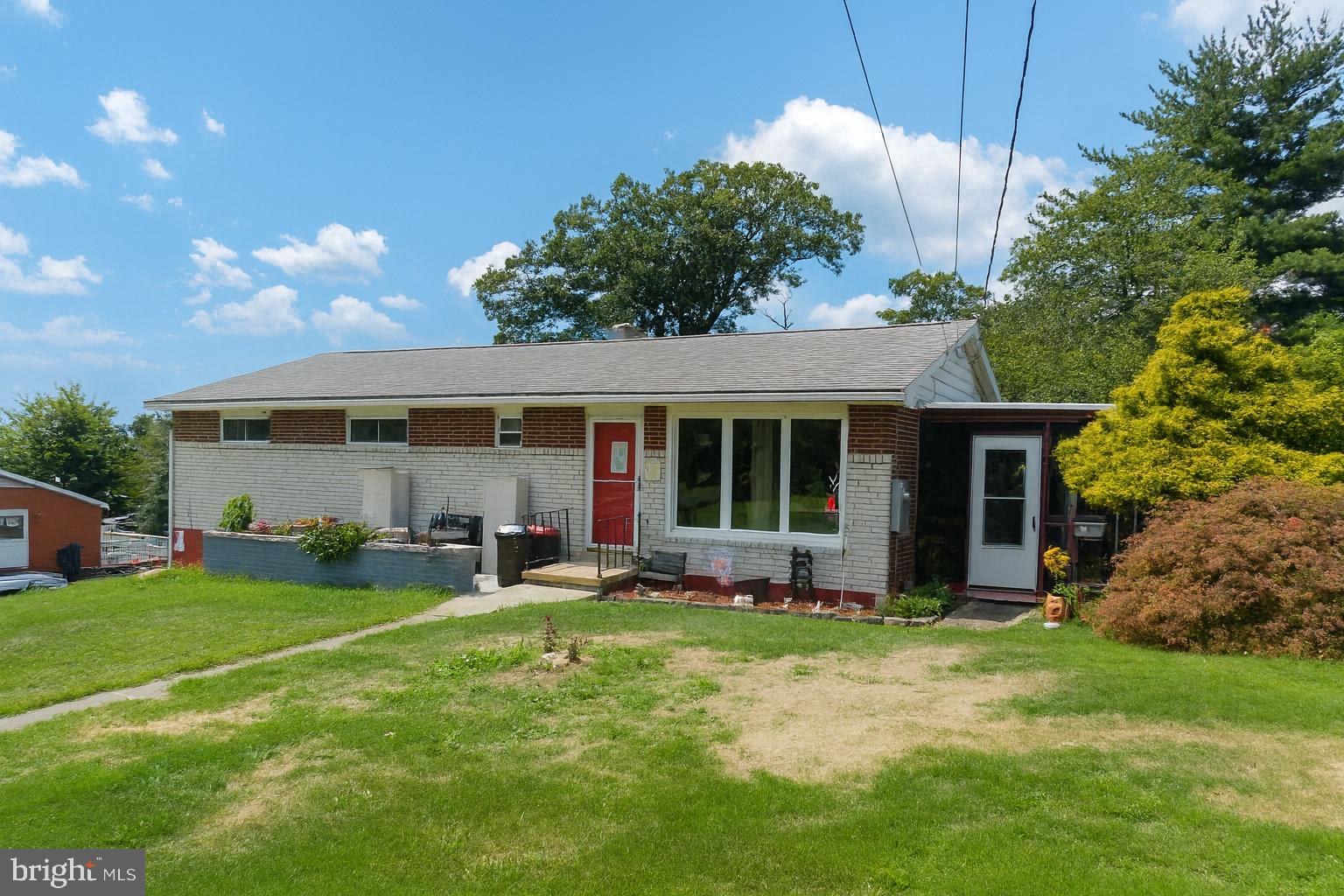 Set at the end of a quiet street with mountain views in a sought-after neighborhood, this solid brick rancher offers a layout that works for many lifestyles. The main level has a spacious living room with a beamed ceiling, a dining room that opens to a fully screened side porch, full island kitchen with plenty of cabinet space, three bedrooms with ample closet space, and a full oversized bath. The lower walkout level adds versatility with a bar area, a half bath, and a large open space—use it as a fourth bedroom with its own entrance, a home office, or a recreation room. From here, step out to a covered rear patio for a second spot to relax or entertain. With its flexible floor plan and private location, this home is ready for you to make it your own!