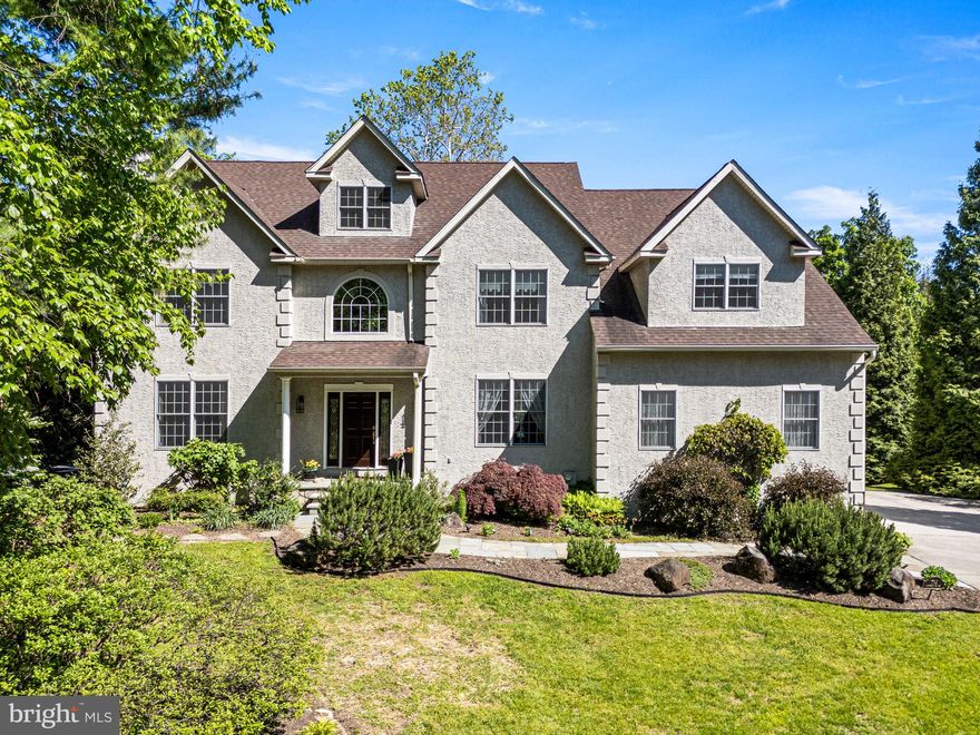 Tucked away on a quiet cul-de-sac and backing directly to Fairmount Park, 734 Cornelia Place feels worlds away from the city while sitting right in the heart of Chestnut Hill. Towering trees, sweeping greenery, and direct access to miles of wooded trails create an incredibly private setting just moments from the neighborhood’s beloved shops, restaurants, and train station.

A bright two-story foyer welcomes you into the home, flanked by a formal living room and elegant formal dining room. A butler’s pantry with dry bar connects seamlessly to the eat-in kitchen, featuring an island with bar seating, double wall ovens, a 5-burner cooktop, glass-front cabinetry, and a sunny breakfast area overlooking the rear deck and yard. Sliding glass doors provide access to the oversized trex deck, while the kitchen also conveniently connects to the two-car garage, mudroom, and laundry room.

The kitchen opens directly into the impressive two-story family room, where soaring windows flood the space with natural light and a wood-burning fireplace creates a warm and inviting atmosphere. An office and a centrally located powder room complete the main level. 

Upstairs, the sunlit hallway overlooks both the foyer and family room below. Through double doors, the spacious primary suite offers hardwood floors, a tray ceiling, two walk-in closets, and French doors leading to a private sitting room or office overlooking the backyard. The beautifully updated primary bath features radiant heated floors, vaulted ceilings with exposed beams, a striking stacked stone accent wall, double vanity, walk-in shower, and separate molded stone soaking tub.

Three additional bedrooms, each with ample closet space, share a full hall bath with double vanity and are complemented by a large walk-in hall linen closet.

The walk-out lower level provides an incredible extension of the home with high ceilings and oversized windows that fill the space with light. Ideal for entertaining, recreation, or additional living space, the finished basement also includes a full bedroom with double closets, a full bath with walk-in shower, a walk-in closet, sliding glass doors to the patio, and a large unfinished storage area.

The backyard is truly the highlight of the home, offering a setting that feels immersed in the beauty of the park. An oversized deck overlooks the expansive yard surrounded by mature trees and directly adjoins Fairmount Park, creating a private outdoor retreat with breathtaking natural views and direct access to miles of scenic trails. Ideally located in the heart of Chestnut Hill, the home is just moments from the neighborhood’s beloved shops and restaurants, as well as only a few blocks from the train station for easy access to Center City and beyond.