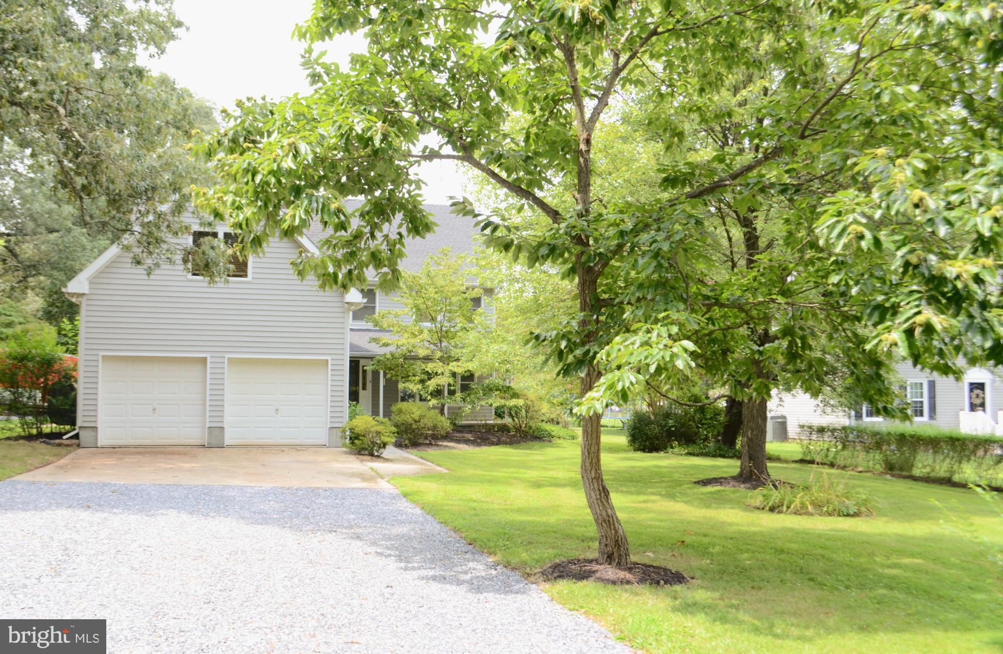 Welcome to this premium custom-built Millersville home (off I-97 and Rt 100), perfectly situated in a quiet neighborhood yet centrally located between DC, Baltimore, and Annapolis. This custom home offers the best of both worlds - a peaceful retreat and easy access to major cities and amenities (minutes to BWI, hospital, shopping, Columbia and Ft. Meade). Nestled on a sprawling 1.6-acre lot with mature trees and a picturesque backdrop of an unbuildable protected area, this property provides a sense of tranquility and privacy. As you step inside, you'll be greeted by a custom-designed three-story home featuring four bedrooms and three full baths. Andersen insulated windows throughout the home and five skylights provide natural light and energy efficiency. Recently enhanced with stunning custom hardwood floors throughout, this residence exudes timeless elegance. The third-floor space has been thoughtfully transformed into a brand-new oasis, complete with skylights, and a charming balcony library, creating the perfect spot for relaxation or creative pursuits. The second-floor primary bedroom suite is a true sanctuary with open ceilings, a cozy fireplace, a walk-in closet, and a luxurious bathroom with a large shower and jacuzzi tub. Upstairs, you'll also find three additional large bedrooms, a third full bathroom, and the added convenience of wood Venetian blinds throughout. Enter the home from the large covered porch, and to the right is an intimate front room space. To the left, there is a full bath with a shower, a laundry room with great storage, and access to the oversized garage. Continue past the hardwood stairway, and you'll find a spacious great room with a massive custom-built fireplace equipped with a wood stove, serving as the focal point of the living space. The living area and dining space seamlessly flow into the spacious kitchen with a lovely bay window and hickory hardwood cabinets. French doors in the dining area lead outside to a patio and a generously sized backyard, perfect for entertaining and enjoying the outdoors. In addition to the large attached two-bay garage (20’x34’), there is an additional single-car detached two-story studio/garage/workshop/shed (22’x24’). This versatile space offers ample room for creativity! It can house a workshop, tools, gardening supplies, and various projects on the lower level, while the upper level is poised to serve as a spacious studio. The property is further enhanced by raised beds, fig trees, and blueberries in the sprawling backyard. A second 24’x24’ backyard patio, surrounded by lilies, provides an idyllic and peaceful setting for entertaining friends. Having completed recent major renovations throughout, this home is move-in ready and includes freshly painted interiors, a brand-new roof installed two years ago, and a new septic pump. It is connected to city water, ensuring convenience and reliability. No HOA allows for endless new dreams to be made. Don't miss the opportunity to own this exceptional Millersville residence, where comfort, creativity, style and convenience come together seamlessly.