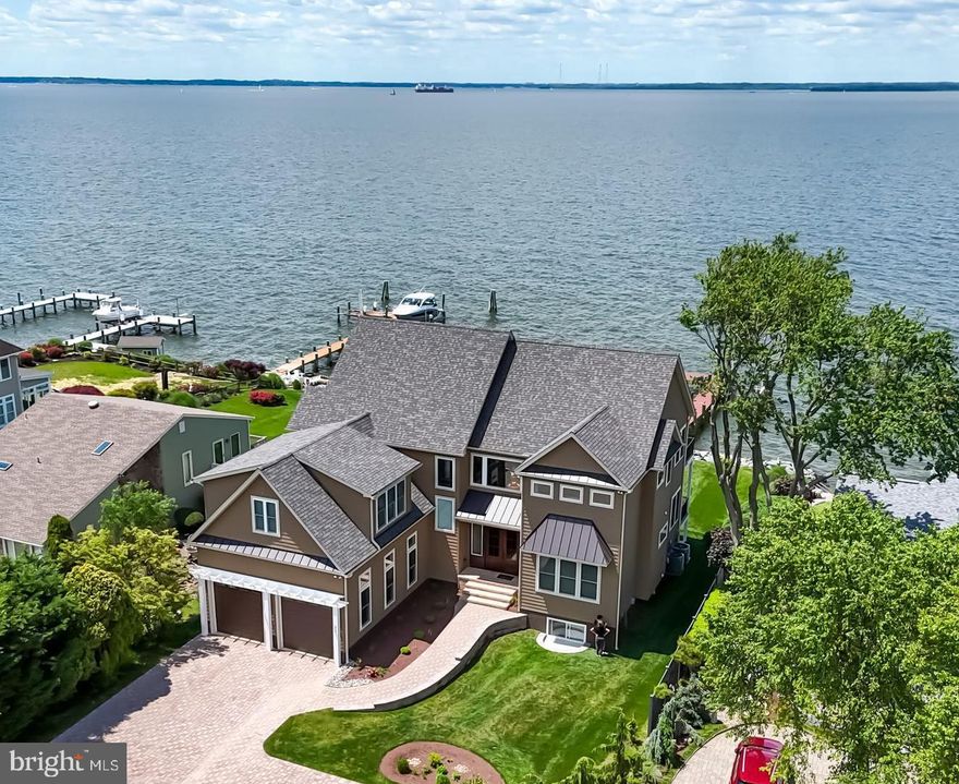 Nestled along the sparkling shores of Chesapeake Bay, this exquisite custom-built home built in 2023-24, stands as a testament to luxury and refined living. No detail has been overlooked in the creation of this magnificent residence, where no expense was spared to craft a haven of beauty and comfort. Nature's wonders unfold before your eyes as migrating birds gracefully traverse the skies and wildlife thrives in their natural habitat. The enchanting sunsets paint the horizon with a kaleidoscope of hues, each evening offering a spectacle, it feels as if time stands still. These unparalleled sunsets, a symphony of colors, are a testament to the unparalleled beauty of this unique setting.
 As you step inside, you are greeted by a symphony of an open floor plan providing openness and light, with large slider doors creating a vista of water views across the open space. Vaulted ceilings on the second floor add a touch of airiness and grace. Every inch of this home has been meticulously designed and crafted to offer the epitome of comfort and style.
Indulge in the ultimate modern living experience across three levels, where custom features abound. From the three living / family rooms that beckon relaxation, a game room that promises endless entertainment, every corner of this home is designed to cater to your every need and desire.
With six bedrooms, including three primary suites, tranquility and privacy are always at your fingertips. An elevator effortlessly connects all three floors, ensuring accessibility and convenience for all. Step outside onto the Trex decks and porches, where the beauty of the outdoors unfolds before your eyes. Take in the panoramic views of the bay, feel the gentle breeze caress your skin, and immerse yourself in the serenity of waterfront living.
This home is not just a residence; it's a sanctuary where luxury meets functionality, and every detail has been thoughtfully curated to elevate your lifestyle. From the new rip rap that protects the shoreline to the pier that extends a gracious invitation to explore the waters, every feature speaks to the uncompromising quality and craftsmanship that defines this extraordinary property. Welcome home to a life of unparalleled splendor and indulgence. Location, Location, Location is a part of this unparalleled experience with a quick commute to bay bridge, shopping and much more.
Experience a lifestyle of unparalleled luxury and tranquility in this Chesapeake Bayfront retreat, where every day is a celebration of nature's splendor and the essence of waterfront living.