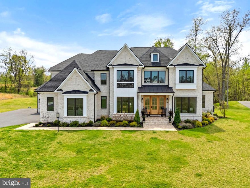 Want to build a custom home near Middleburg, but not wait for new construction? Welcome to Affirmed Park Court …a stunning French transitional home located just minutes from downtown Middleburg in Banbury Cross Reserve, an exclusive enclave of custom homes. Offering over 6,000 square feet of beautifully finished living space, this home was thoughtfully designed for today’s discerning buyer and is move-in ready. The floor plan includes 4 bedrooms with ensuite baths, plus the flexibility for a 5th bedroom and bath on the lower level, ideal for guests or an in-law suite. Privately sited at the end of a cul-de-sac, the premium lot enjoys protected views of fields and woods under permanent open space easement. Stone gate posts and a paved driveway lead to the all-brick residence with a deep front porch, mahogany entry doors, and designer carriage lighting. Inside, wide-plank white oak floors, soaring 10’ ceilings, and extensive custom millwork set the tone. Highlights include a formal dining room, private office, living room with built-ins, wet bar, and a dramatic family room with coffered ceilings and a floor-to-ceiling stone fireplace. The gourmet kitchen features Omega cabinetry, quartz countertops, a 12’ island, and premium Sub-Zero, Wolf and Cove appliances. The kitchen opens to the light-filled breakfast room with doors to the rear deck, complete with a gas-plumbing for a grill and automatic awning for outdoor entertaining. Upstairs, the luxurious primary suite offers a sitting room, dual walk-in closets, and a spa-like bath with soaking tub and oversized shower. Three additional ensuite bedrooms, plus a well-appointed laundry room with double washers and dryers, complete the second floor. The unfinished lower level offers abundant potential for recreation, fitness, a guest space and storage. Residents enjoy walking the community roads and the protected open spaces and easy access to Route 50, Dulles International Airport, and Washington, DC. Please see documents section for the extensive list of upgrades and custom features.