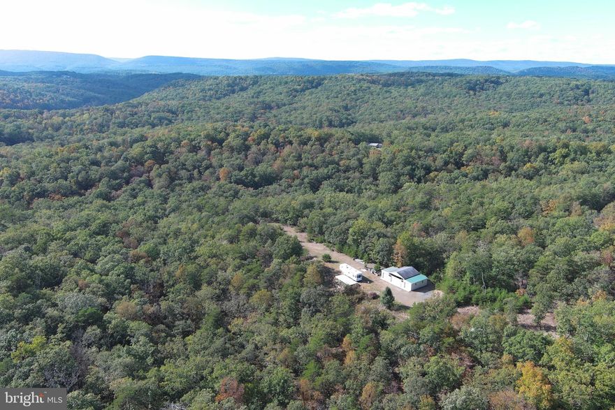 FULLY FUNCTIONAL......14 GORGEOUS ACRES COVERED IN MASSIVE HARDWOODS WITH WET WEATHER STREAM, AWESOME VIEWS, WELL, SEPTIC, ELECTRIC AND PUBLIC WATER AVAILABLE....1200 SQ FT 3 BAY POLE BUILDING WITH POURED FLOOR THAT NEEDS SOME FINISHING TOUCHES.....2005 36FT 5TH WHEEL CAMPER CONVEYS......EVERYTHING ON THE PROPERTY CONVEYS, WHAT YA SEE IS WHAT YA GET....VERY MINIMAL RESTRICTIONS, NO HOA, ONLY 1/4 MILE OFF PAVED ROAD ON STATE MAINTAINED GRAVEL ROAD.....WIDE SECLUDED RIDGE TOP OFFERS MULTIPLE BUILDING SITES.....HUNT, SHOOT, ATV'S.....MOBILE HOMES ALLOWED.....TINY HOMES OK.....WOULD MAKE A GREAT HOME BASE FOR RV ENTHUSIASTS WITH SUCH EASY ACCESS.....THIS PROPERTY HAS SO MUCH TO OFFER AND IT'S READY TO USE DAY 1......YOU CAN FIGURE 40K FOR THE UTILITIES & SITE CLEARING, 40K FOR THE CAMPER & POLE BUILDING, WHICH MEANS YOU'RE GETTING 14 ACRES OF SUPER NICE LAND FOR 40K....THIS ONE'S A NO BRAINER.....IT'S TIME TO STOP THE SEARCH FOR THE PERFECT PROPERTY.....MAKE THE CALL, SET THE APPOINTMENT AND BRING YOUR CHECKBOOK!