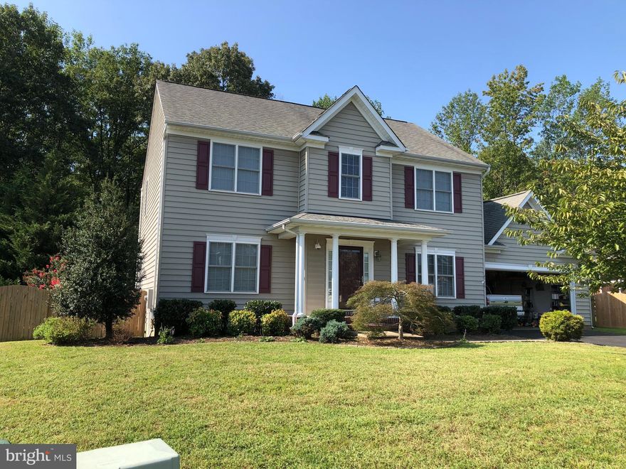 Welcome to your new home.  This large  ready to move in home is waiting for you.  Loads of space, 4 BR, 3 1/2 BA with large master with on-suite and walk-in closet.    Large eat-in kitchen with new hardwoods, separate dining area,  large family room, finished basement with full bath, game room , family/tv room, office area, and exercise room.  65" TV in family/tv room convey.   Large deck and huge patio with outside speaker system overlooking beautiful fenced yard - backs up to woods for privacy.  Located in a great neighborhood just 3 miles from VRE Station, close to dining and shopping. sidewalk community. This won't last long.