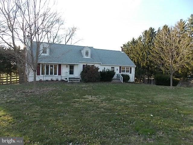 A must see inside , home is larger than it looks. 2 main entrances, 2 fireplaces, 2 family rooms & oversize 2 car garage . Gleaming hardwood floors in l.r. & b.r.'s. Huge family room off kitchen that leads to deck to enjoy the country view. Partially fenced rear yard with pond and circular driveway. Upper level has 2 bedrooms with 2nd family room . Lots of built-ins and storage through out.