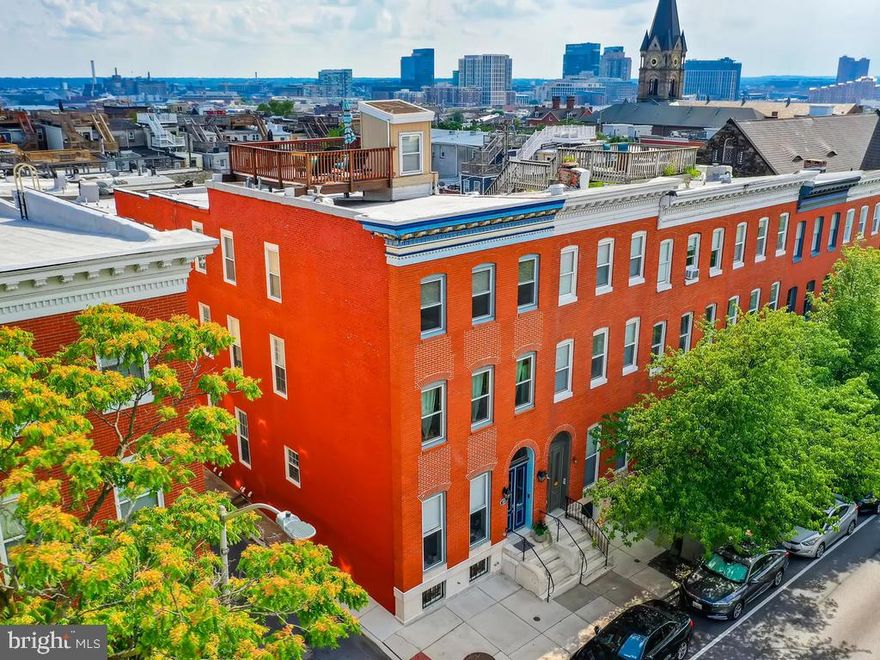 THIS IS THE ONE. Come see this rare gem in the heart of the Historic Butcher s Hill neighborhood. This spacious corner unit is one of the few 18 foot wide homes in the area and has a total of 3840 sq.ft (above grade) living space and the entire house is equipped with a sprinkler system plus a fire door between hallway and living room. The rooms are conveniently cut to maximize space and create an open and bright living space throughout the house. The 1st floor includes an open living and dining space separated by glass-paned double doors. Enjoy high ceilings, large windows, and relax by the gas fireplace. Traditional meets modern with beautiful crown molding, accentuating trim, original hardwood floors, and designer lighting. Installed roof speakers provide the perfect ambiance for any occasion. Also, a powder room is conveniently located just beneath the stairs. The kitchen is characterized by a huge inviting island and a commercial-grade premium Viking range. This kitchen includes recently purchase stainless steel appliances, including a large double door fridge with a water and ice dispenser. Easily manage prep and clean up with not one but two dishwashers and two large sinks. There is ample storage space in the form of large cabinets and a roomy walk-in pantry with plenty of shelf space. The 2nd and 3rd levels of the house offer 4 extra-large bedrooms, each complete with a full bath. The two rear bedrooms even include large balconies overlooking the neighborhood and the Baltimore cityscape. Spacious in-room closets and a walk-in closet on the 2nd floor create ample storage capacity. Scenic is an understatement when looking from this large and optimally situated roof deck. Enjoy a 360 panoramic city and water view and get ready to have the best seat in town during local airshows and firework displays. The house comes with 2 gated, and securable parking spots under a vine-covered pergola, protecting access to the rear of the house. Find your little piece of green in the city with a cozy outside area to grill or enjoy the evenings or summer entertaining. This house really does have it all; recent updates include bathroom renovations, fireplace, walk-in closet, window treatments, designer lights, walk-in pantry, 2 recently purchased HVAC units, 2 recently purchased water heaters, refrigerator, dishwasher, as well as many other touch-ups to make this a move-in ready option. Walking distance to Johns Hopkins, Patterson Park, Fells Point, Harbor East, Canton Square, Canton Park, and local eateries, as well as close proximity to shopping centers such as Safeway, Whole Foods, Sprouts, Harris Teeter, and Target, make life in the city a breeze. Also, easy access to I-83 and I-95.Don t miss the opportunity to own this one of a kind property in this beautiful part of Baltimore City. Includes a transferable home warranty renewed in July. Don't miss the virtual tour and 3D Matterport.